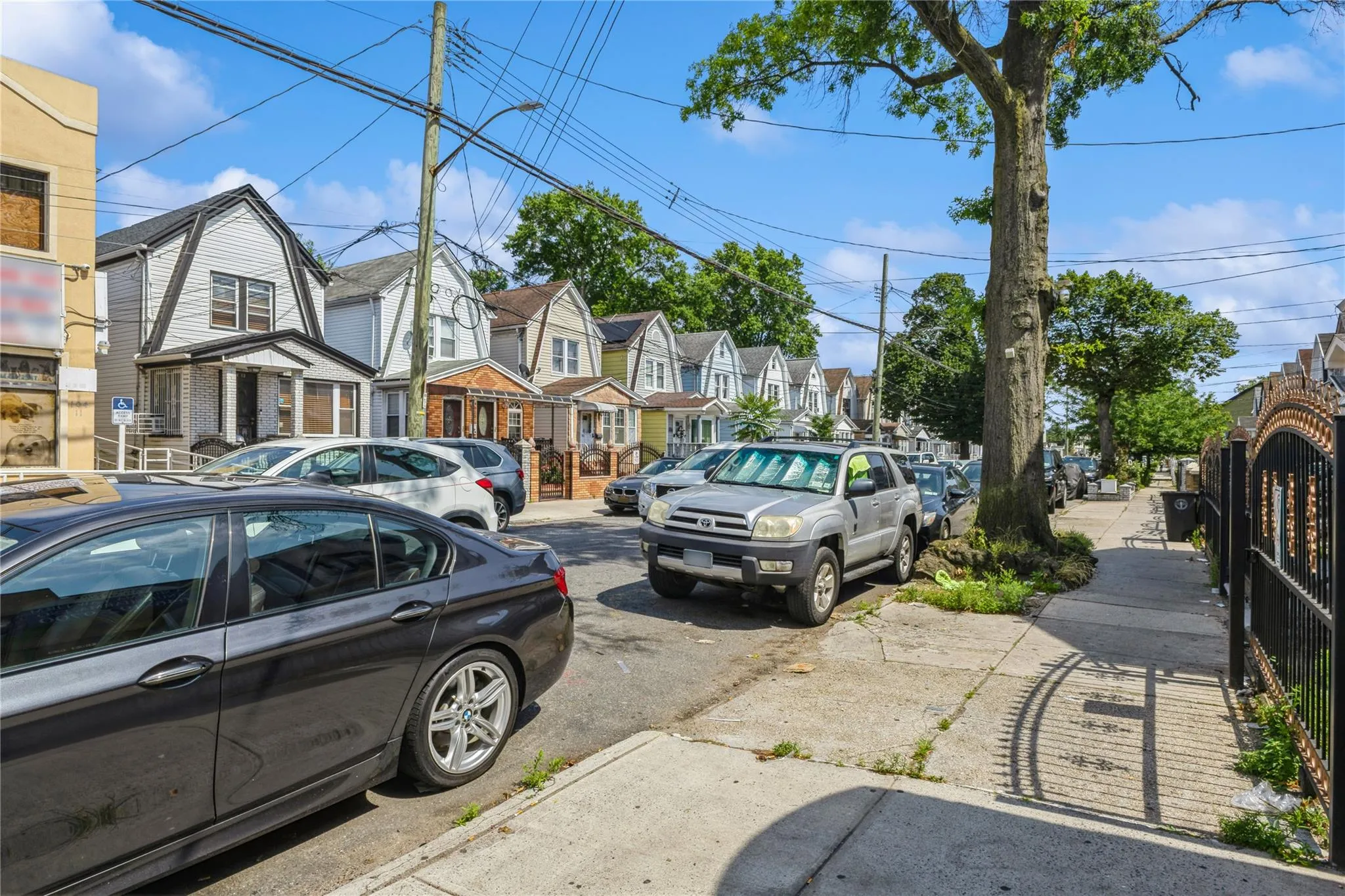 View of asphalt street with a residential view, sidewalks, and street lights View of asphalt street with a residential view, sidewalks, and street lights