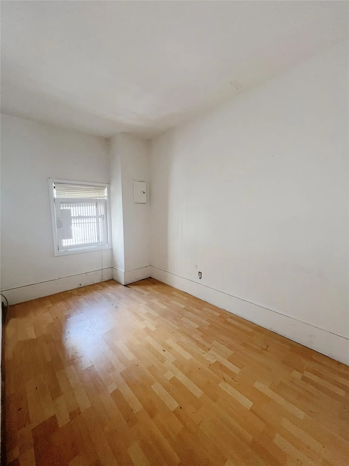 Spare room with light wood finished floors and baseboards Spare room with light wood finished floors and baseboards