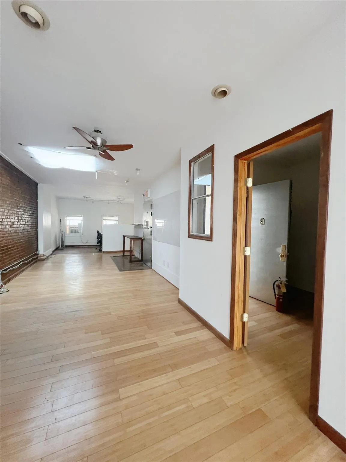Unfurnished living room with ceiling fan and light wood-style floors Unfurnished living room with ceiling fan and light wood-style floors