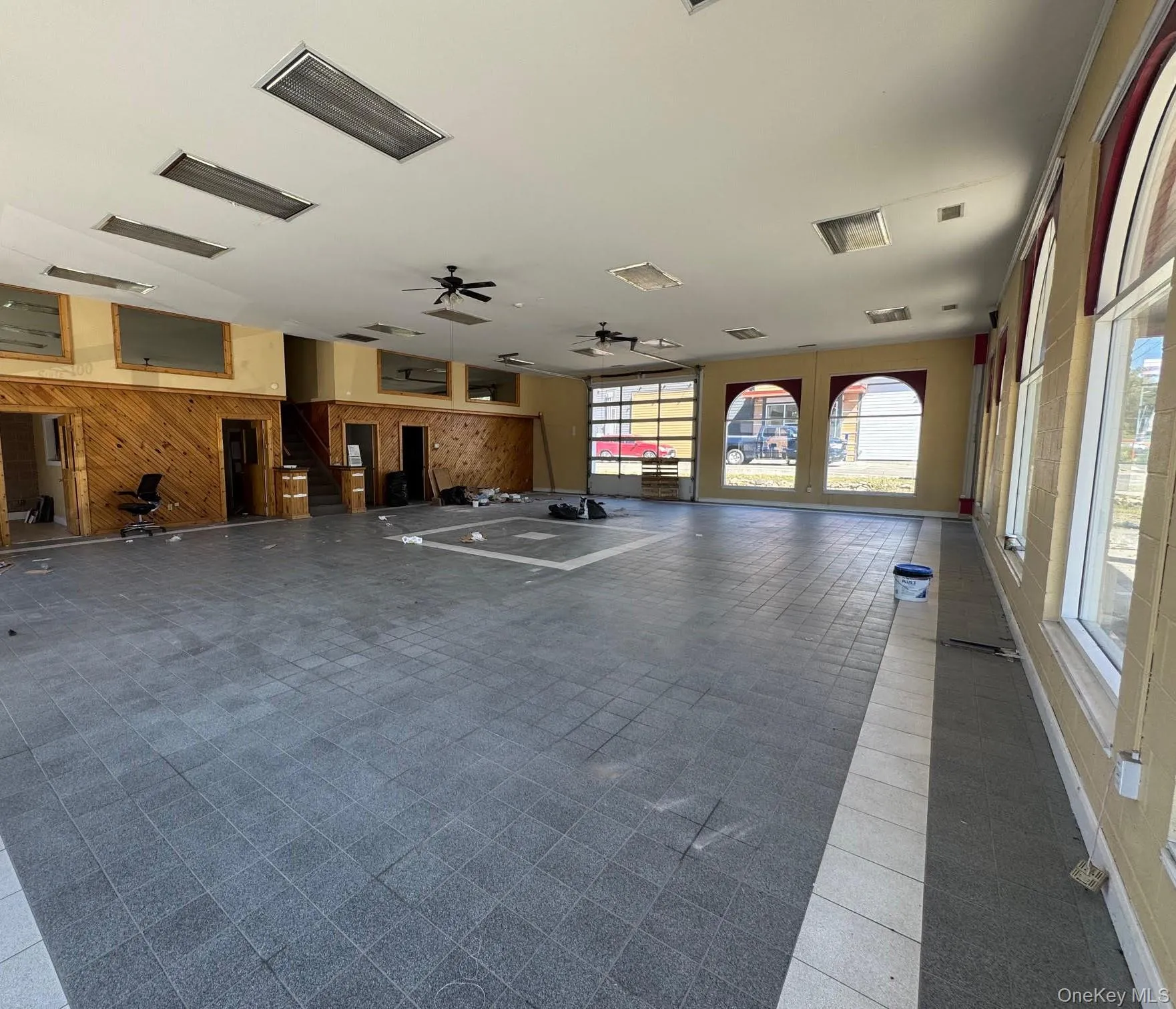 Exercise room featuring wooden walls and ceiling fan Exercise room featuring wooden walls and ceiling fan