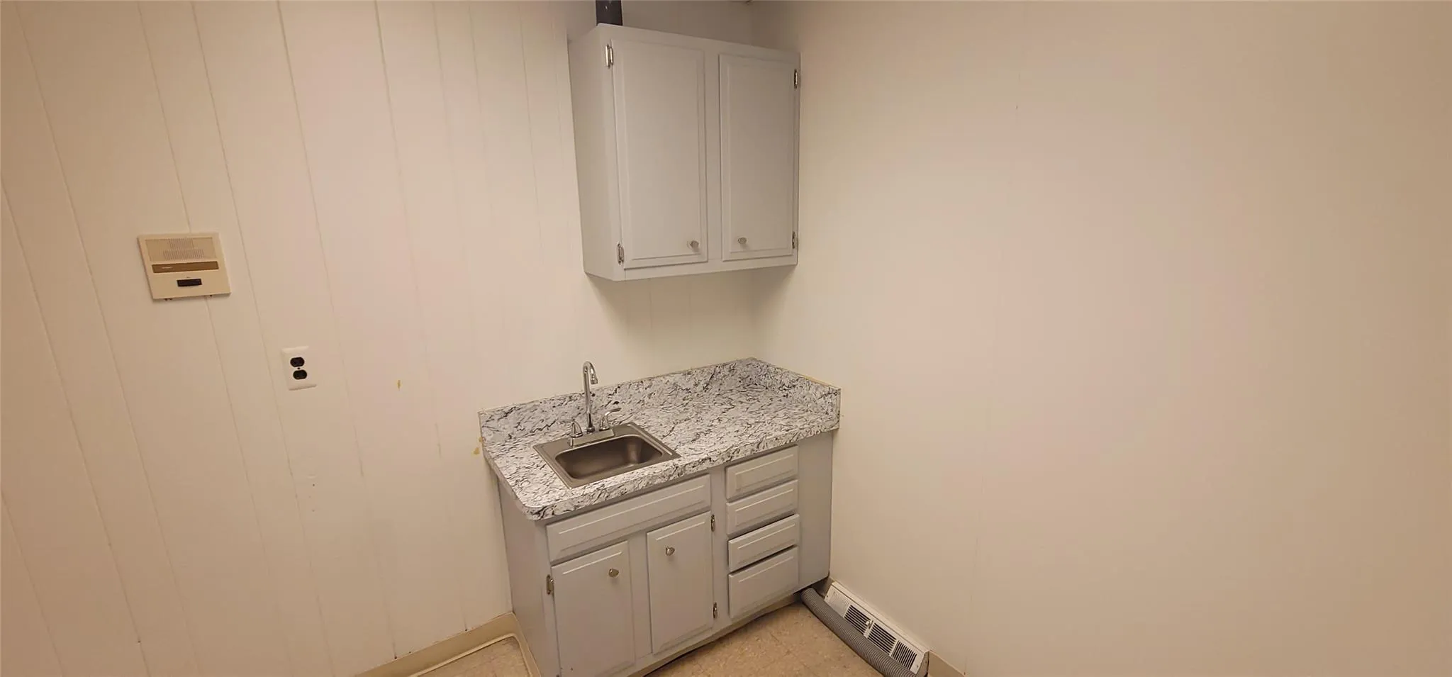 Washroom with a sink and a baseboard radiator Washroom with a sink and a baseboard radiator