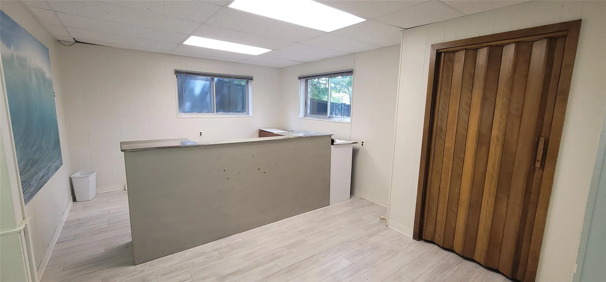 Unfurnished room featuring a paneled ceiling and light wood finished floors Unfurnished room featuring a paneled ceiling and light wood finished floors