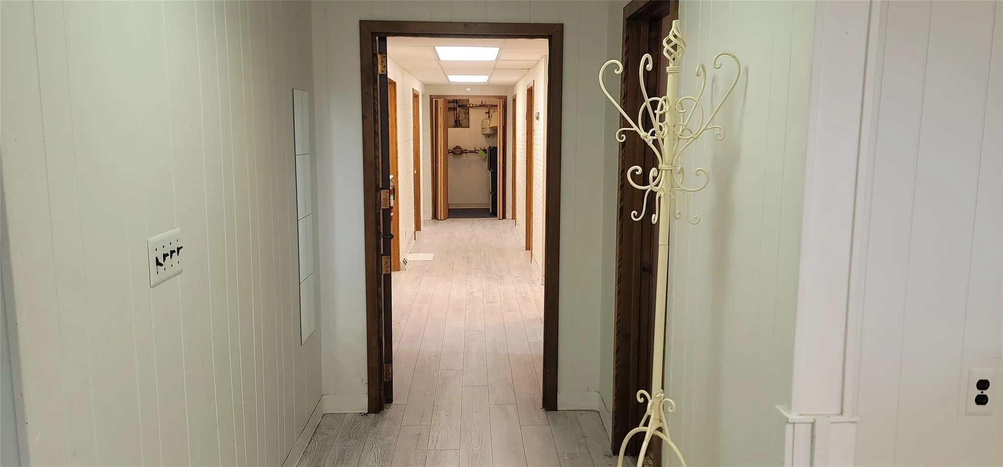 Corridor with light wood-style floors and baseboards Corridor with light wood-style floors and baseboards