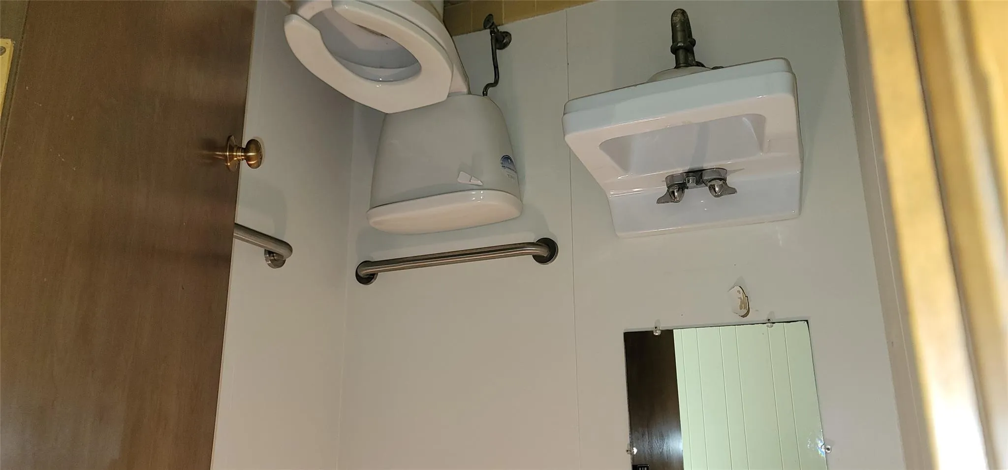 Half bathroom featuring toilet and a sink Half bathroom featuring toilet and a sink