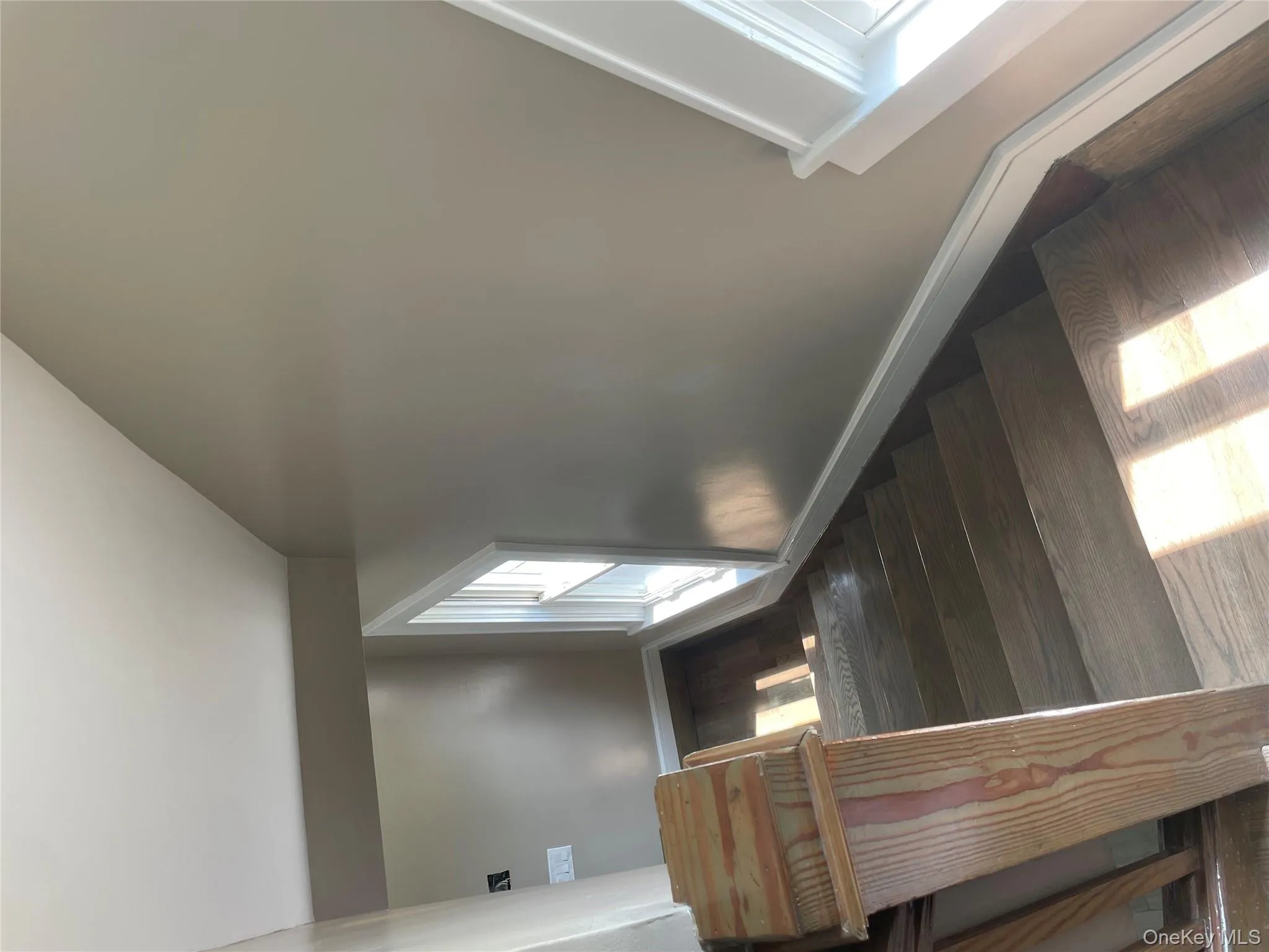 Stairway with wood finished floors and vaulted ceiling Stairway with wood finished floors and vaulted ceiling