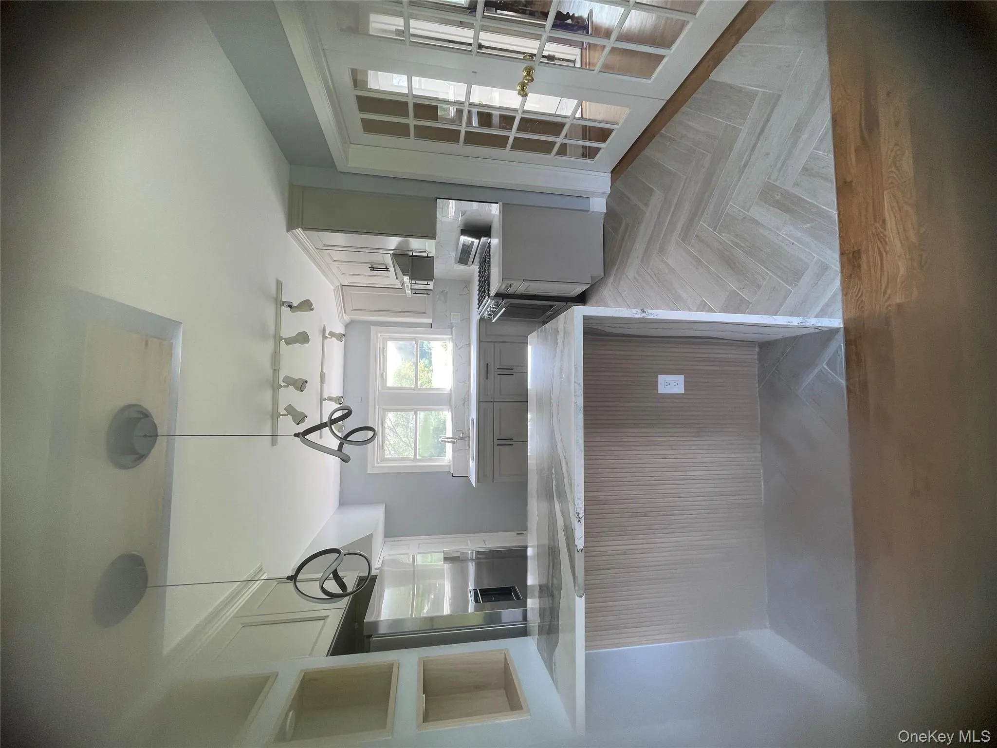 Kitchen featuring a peninsula, range, french doors, fridge, and light countertops Kitchen featuring a peninsula, range, french doors, fridge, and light countertops