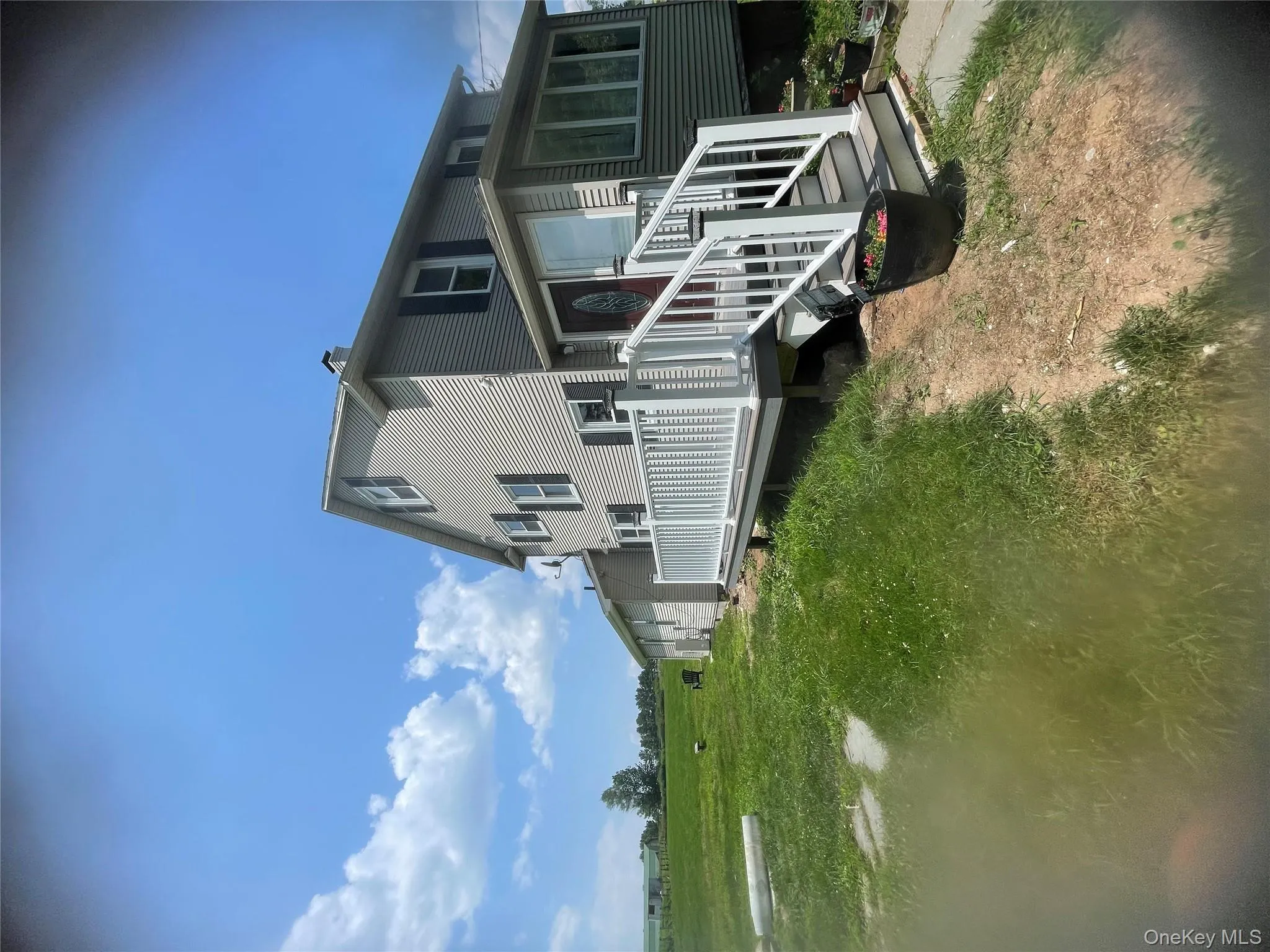 View of side of home with a wooden deck View of side of home with a wooden deck