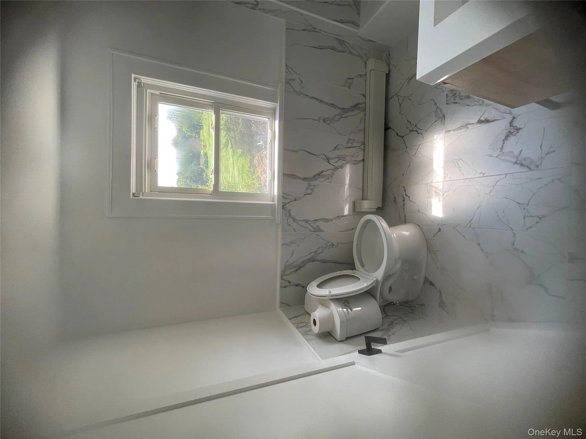 bath featuring a marble finish floors, and vanity bath featuring a marble finish floors, and vanity