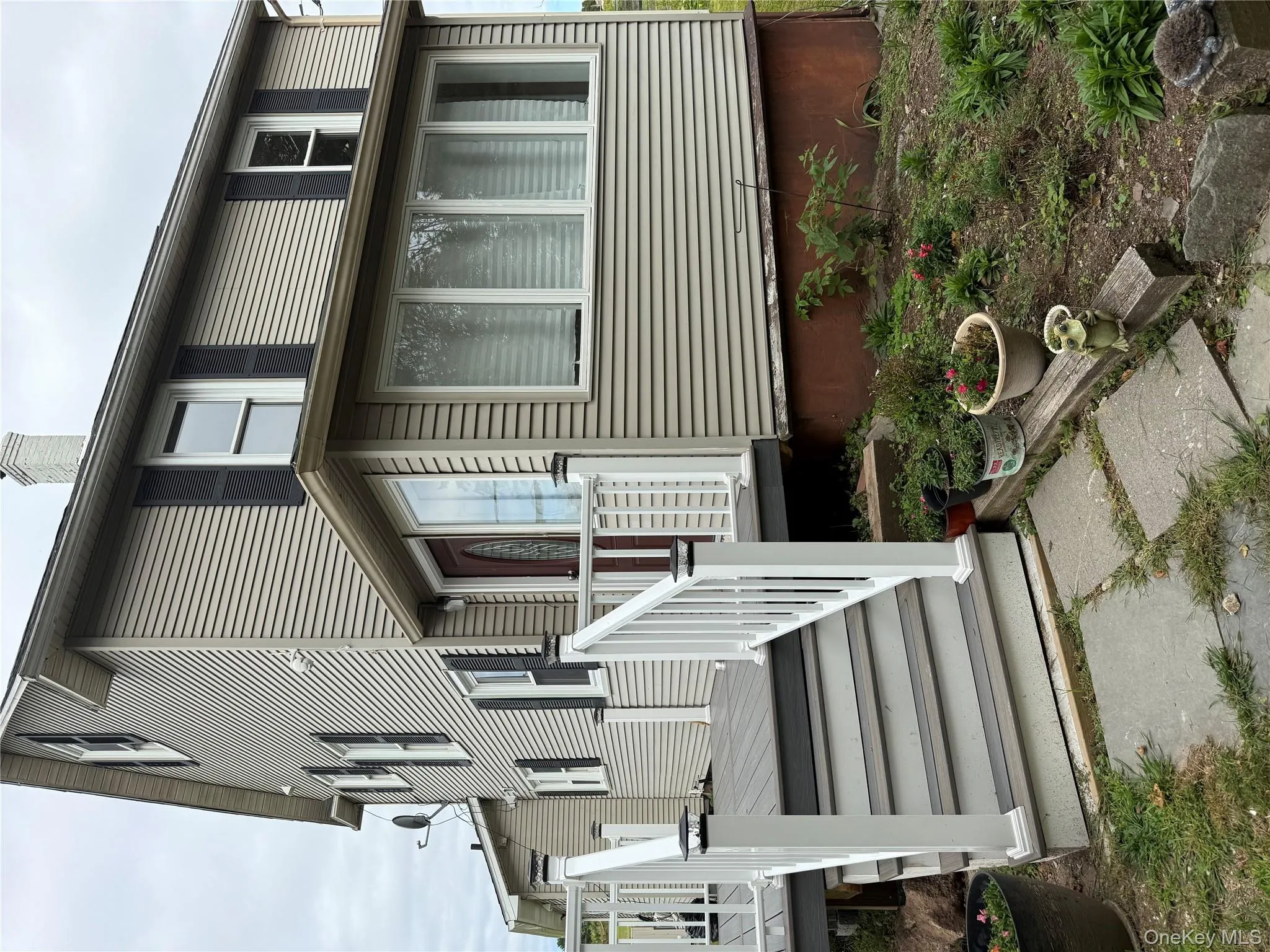 Back of property featuring a chimney and a wooden deck Back of property featuring a chimney and a wooden deck
