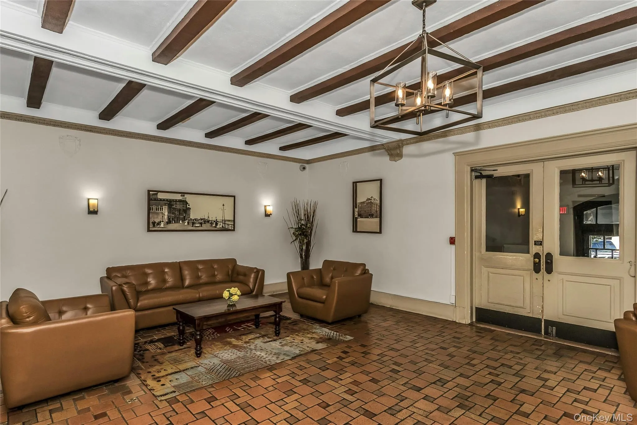 Living area featuring a chandelier, french doors, and beam ceiling Living area featuring a chandelier, french doors, and beam ceiling