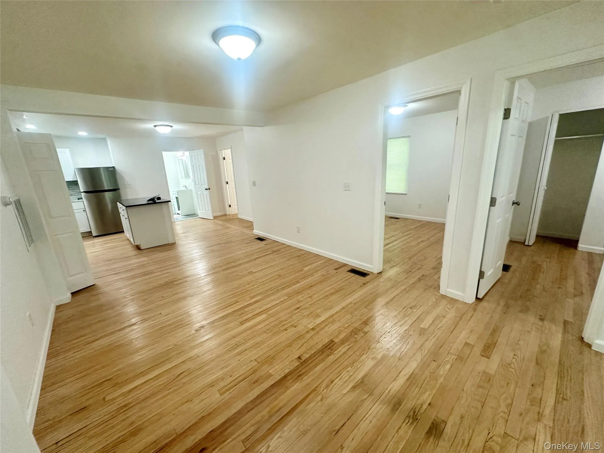Unfurnished living room featuring light wood finished floors Unfurnished living room featuring light wood finished floors