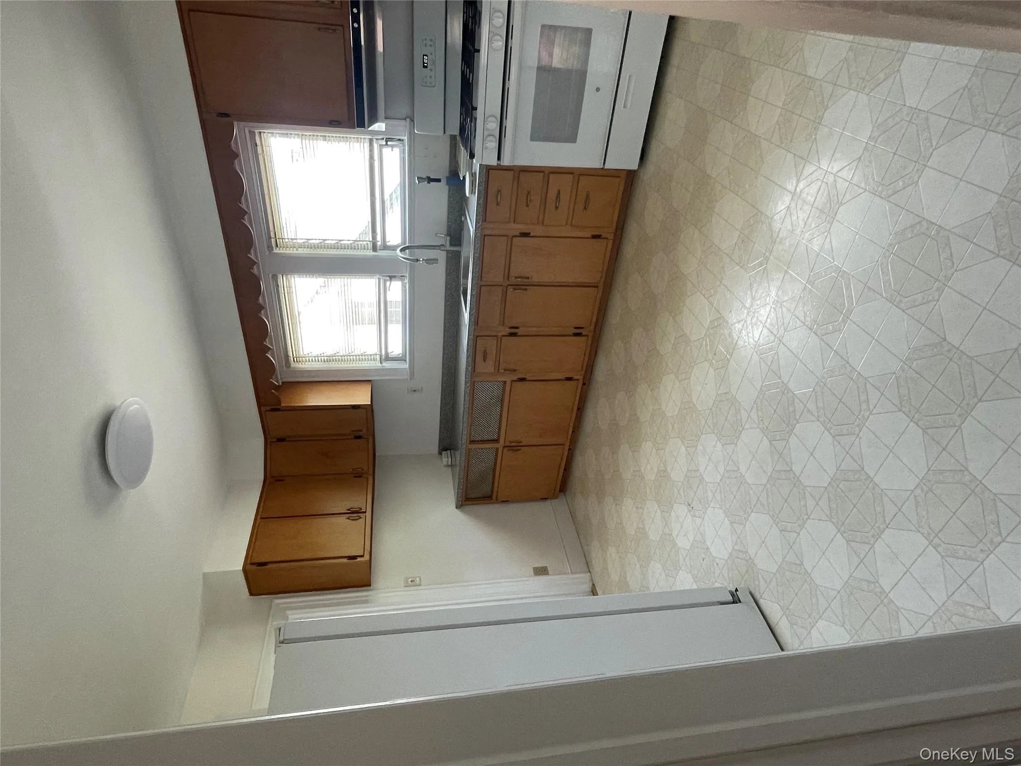 Kitchen with range, refrigerator, light flooring, and healthy amount of natural light Kitchen with range, refrigerator, light flooring, and healthy amount of natural light
