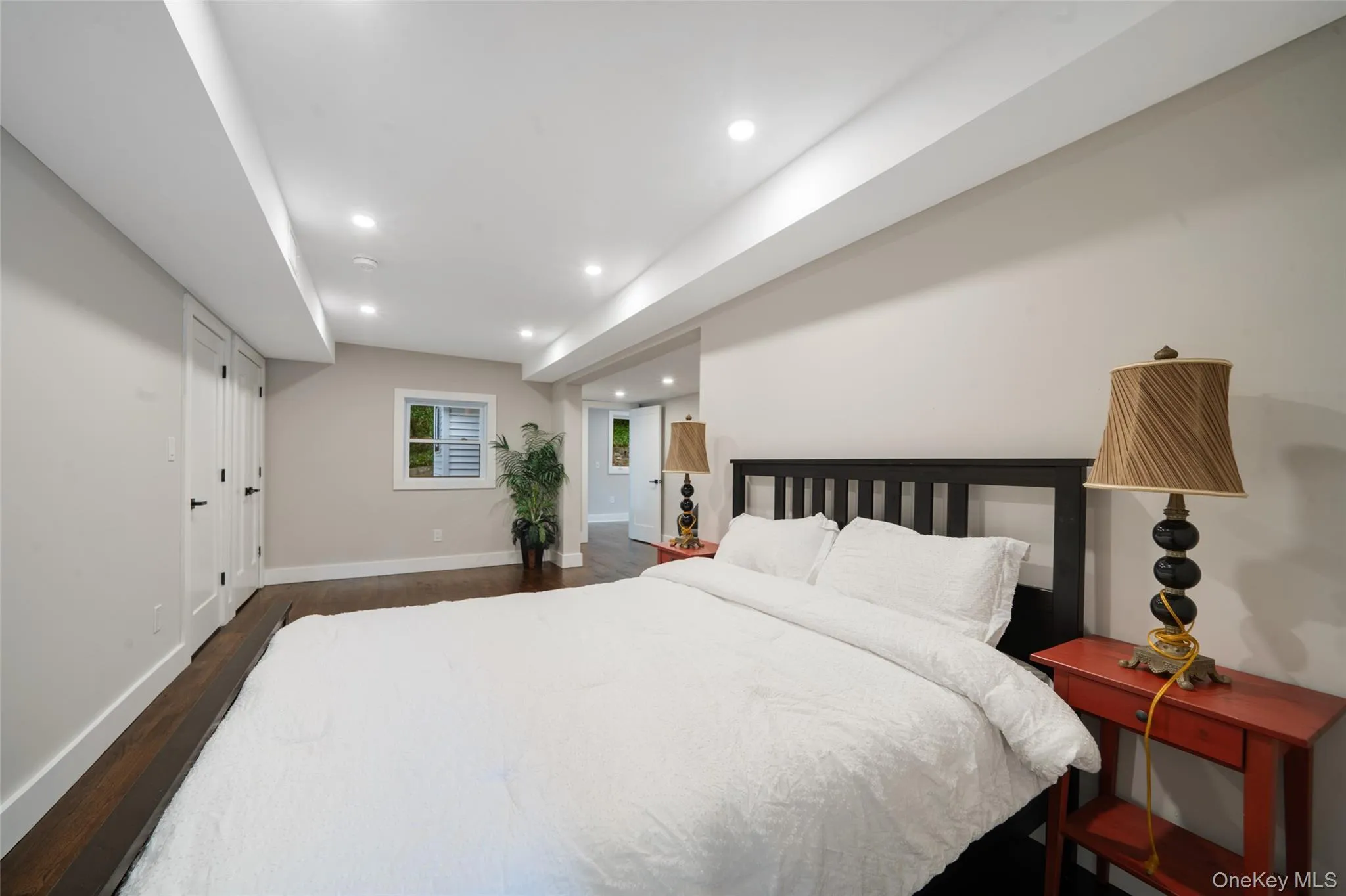 Bedroom with dark wood-style floors and recessed lighting Bedroom with dark wood-style floors and recessed lighting