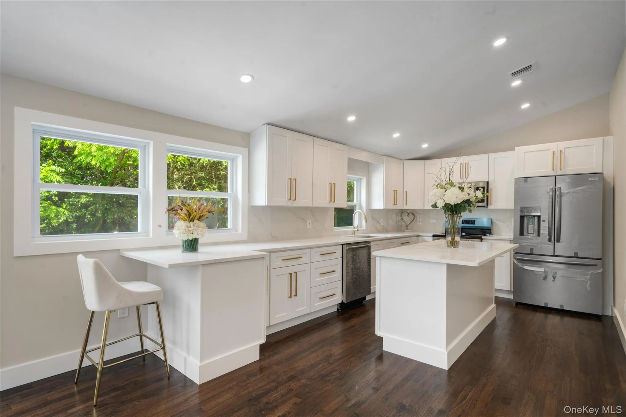 Kitchen with stainless steel appliances, backsplash, light countertops, plenty of natural light, and recessed lighting Kitchen with stainless steel appliances, backsplash, light countertops, plenty of natural light, and recessed lighting