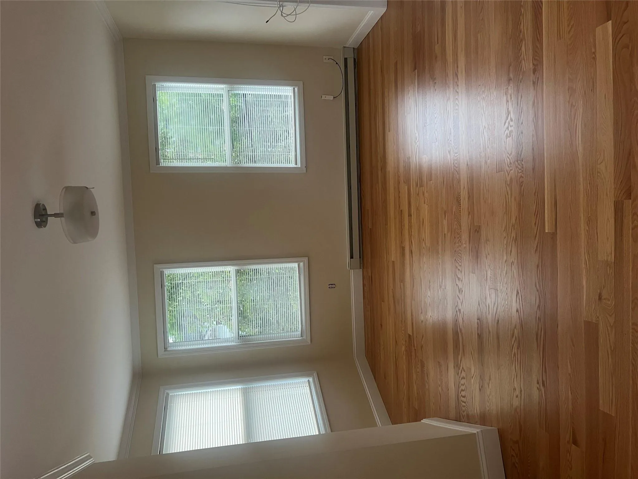 Spare room with ornamental molding, wood finished floors, and a baseboard heating unit Spare room with ornamental molding, wood finished floors, and a baseboard heating unit
