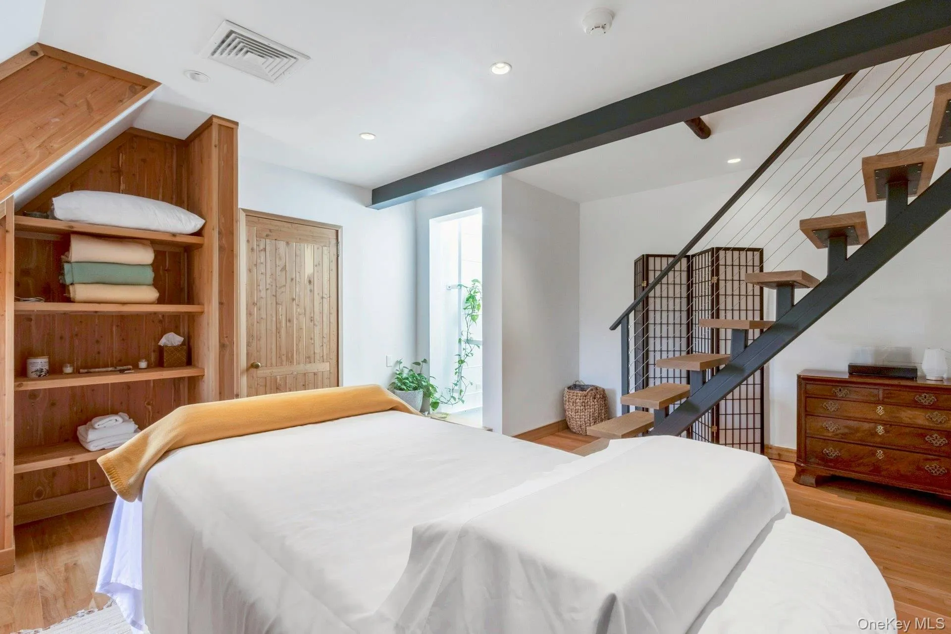 Bedroom featuring light wood-style flooring and recessed lighting Bedroom featuring light wood-style flooring and recessed lighting