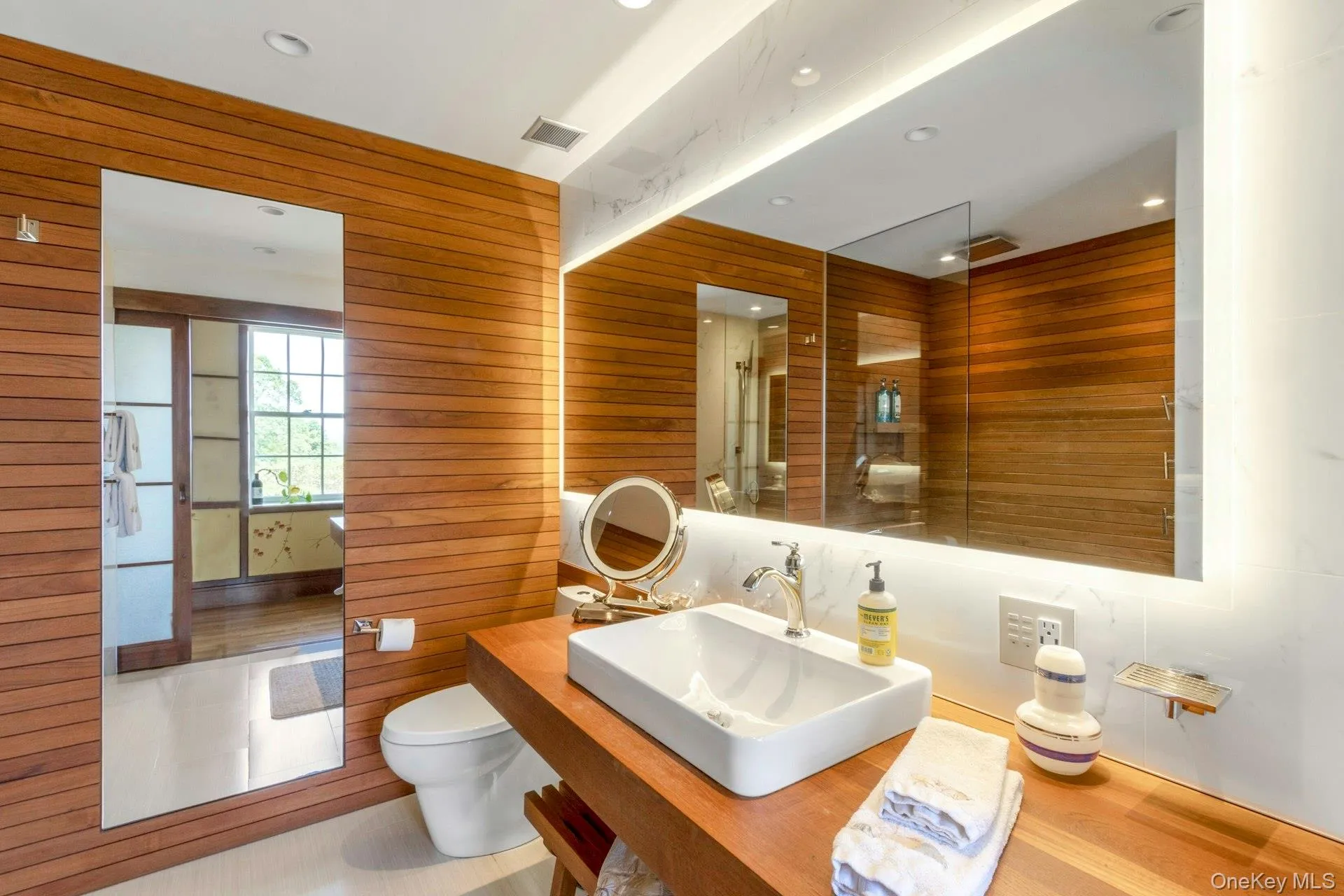 Full bathroom featuring an enclosed shower, vanity, recessed lighting, wood walls, and wood finished floors Full bathroom featuring an enclosed shower, vanity, recessed lighting, wood walls, and wood finished floors