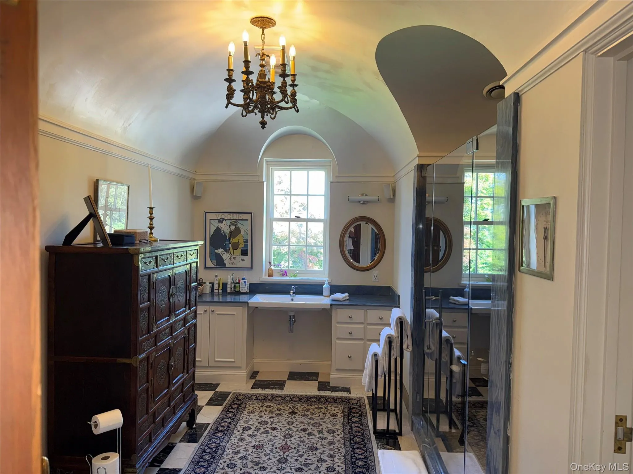 Laundry area featuring a chandelier and a sink Laundry area featuring a chandelier and a sink
