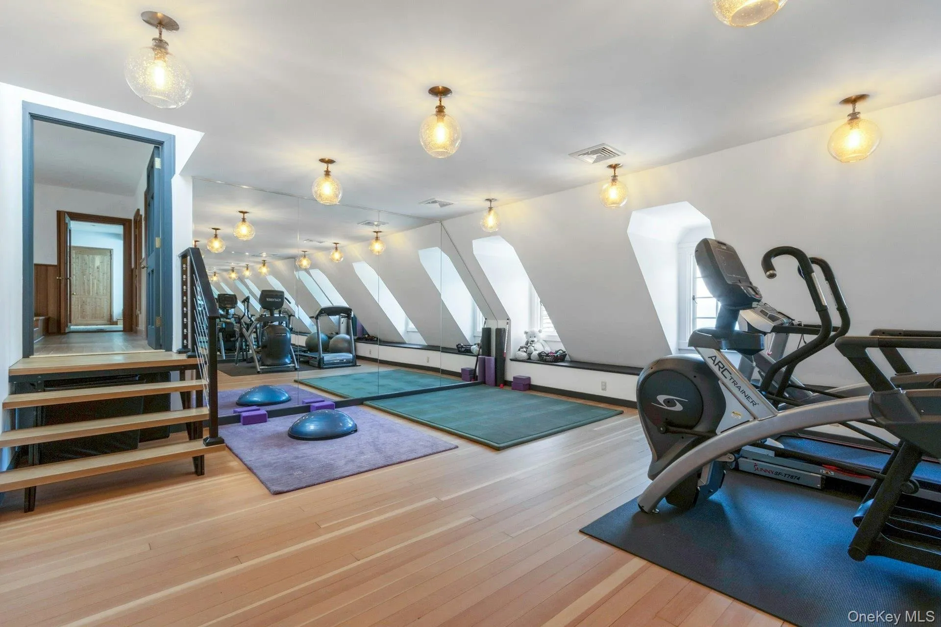 Exercise area featuring wood finished floors and a baseboard radiator Exercise area featuring wood finished floors and a baseboard radiator