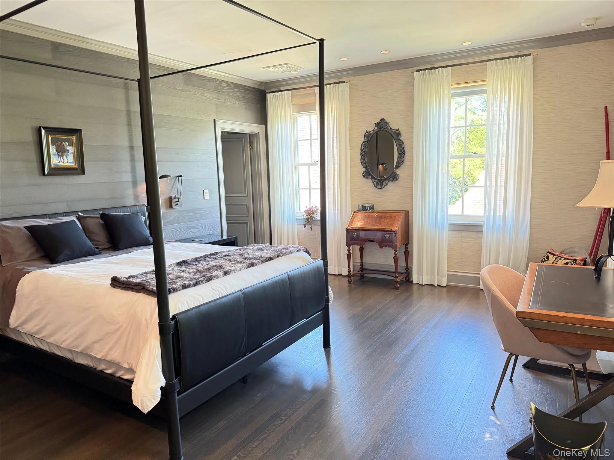 Bedroom with wood finished floors, ornamental molding, and recessed lighting Bedroom with wood finished floors, ornamental molding, and recessed lighting