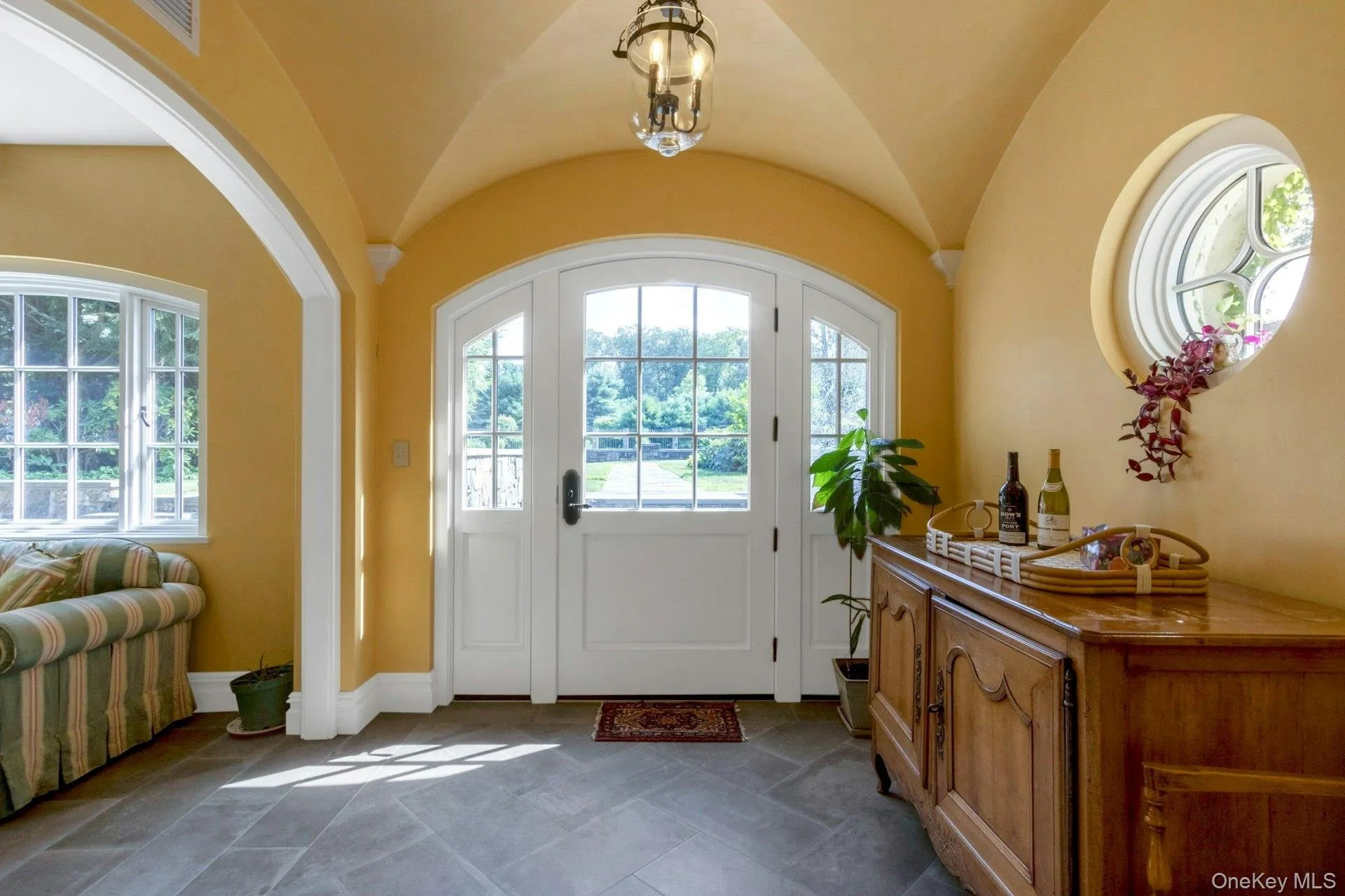Foyer entrance featuring vaulted ceiling and baseboards Foyer entrance featuring vaulted ceiling and baseboards