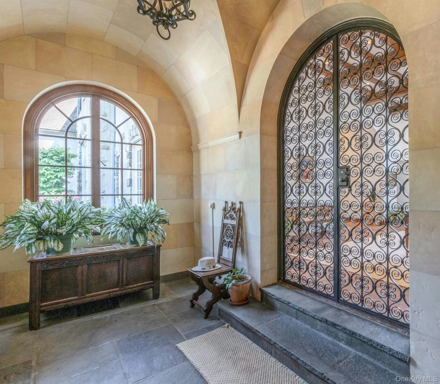 Foyer entrance with arched walkways, tile walls, and lofted ceiling Foyer entrance with arched walkways, tile walls, and lofted ceiling