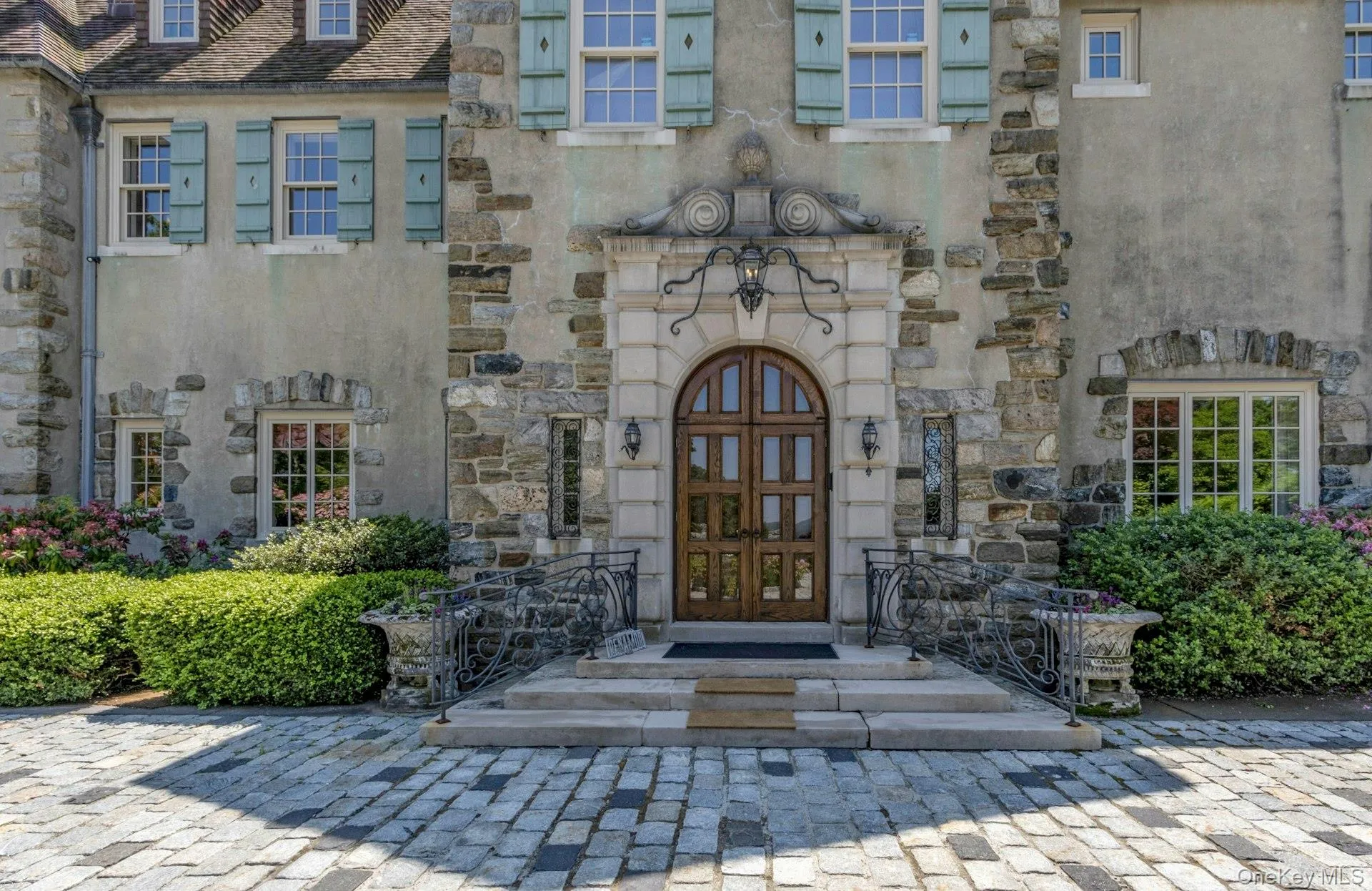 Entrance to property featuring stone siding and french doors Entrance to property featuring stone siding and french doors
