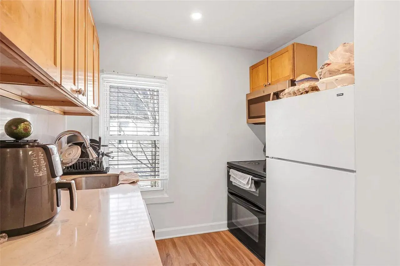 Kitchen with freestanding refrigerator, plenty of natural light, black / electric stove, stainless steel microwave, and recessed lighting Kitchen with freestanding refrigerator, plenty of natural light, black / electric stove, stainless steel microwave, and recessed lighting