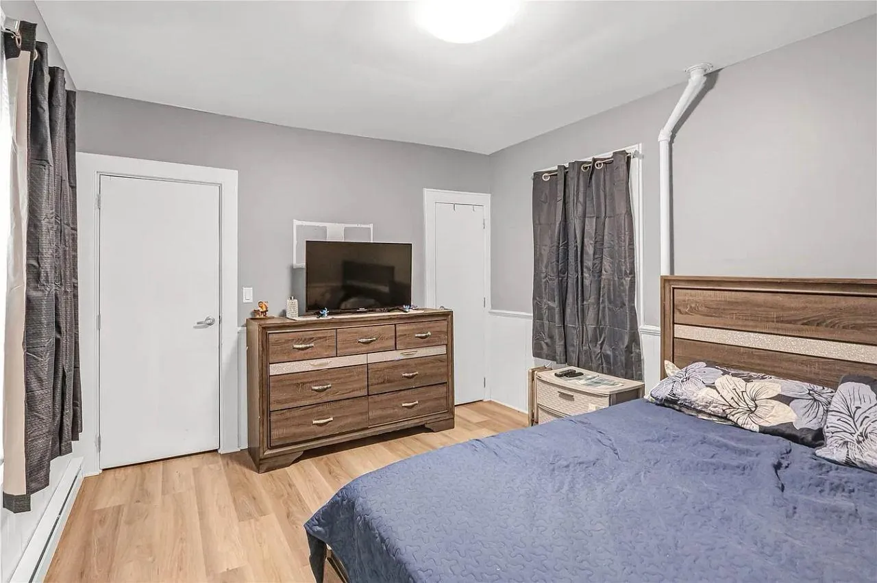 Bedroom featuring light wood-style floors and baseboard heating Bedroom featuring light wood-style floors and baseboard heating