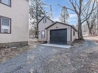 Garage featuring gravel driveway Garage featuring gravel driveway