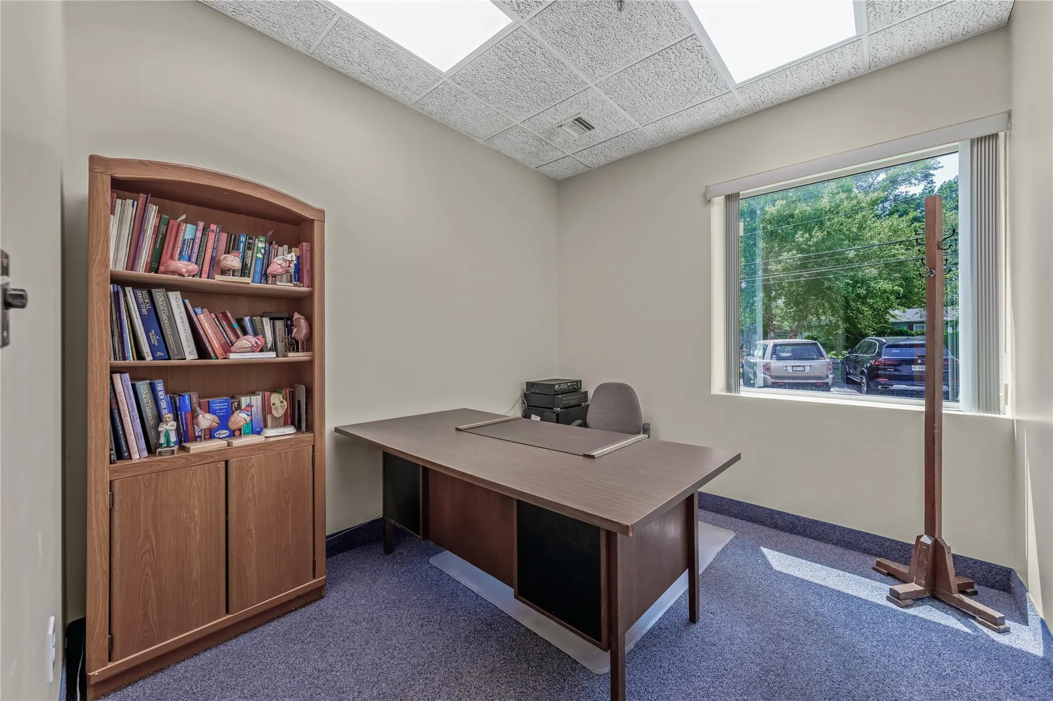 Office space featuring dark carpet and a paneled ceiling Office space featuring dark carpet and a paneled ceiling