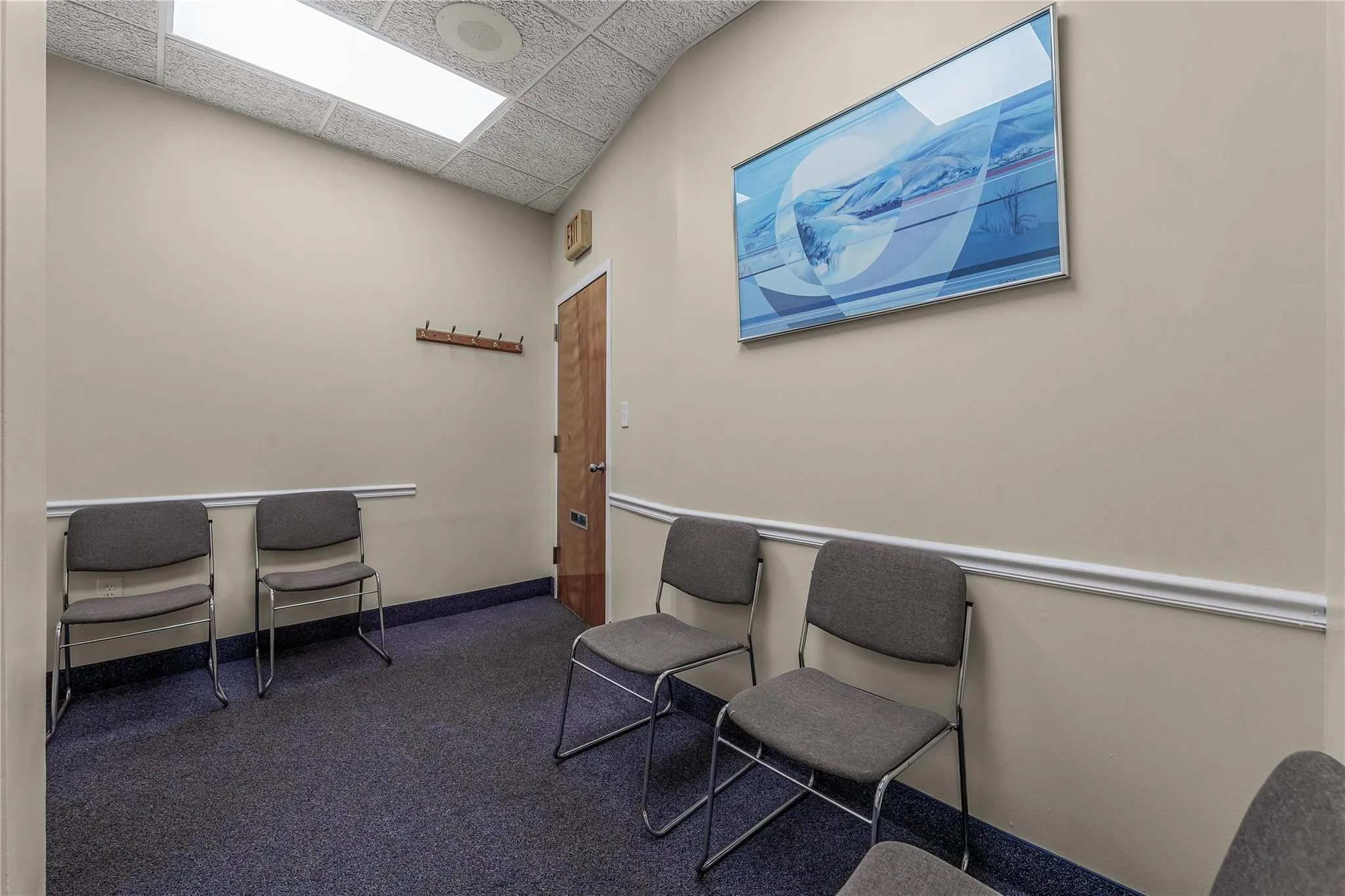 Carpeted home office with a paneled ceiling and baseboards Carpeted home office with a paneled ceiling and baseboards