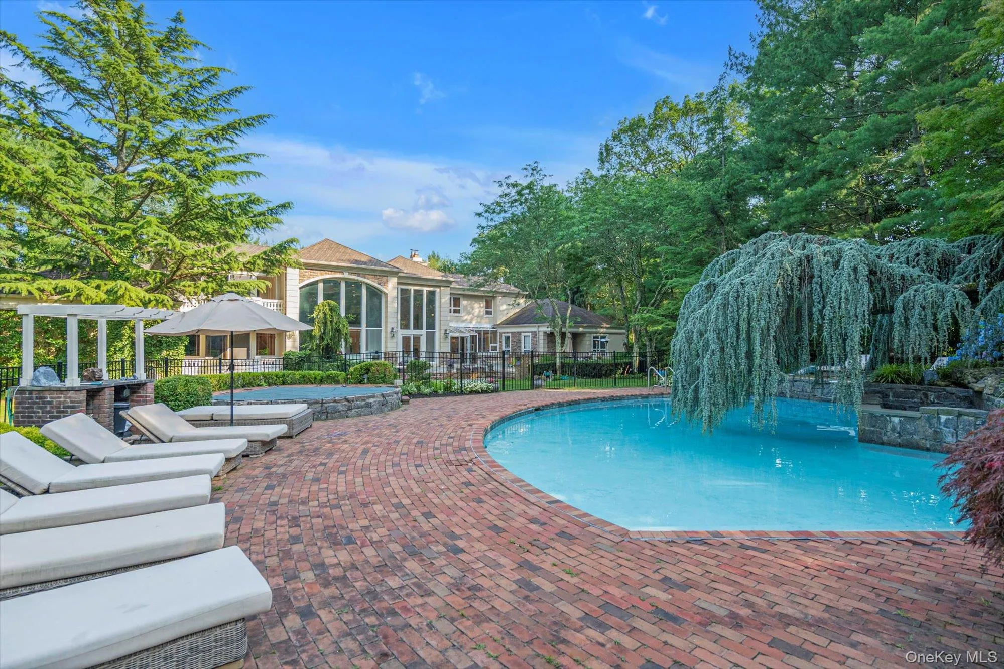 View of pool featuring a pergola and a patio area View of pool featuring a pergola and a patio area
