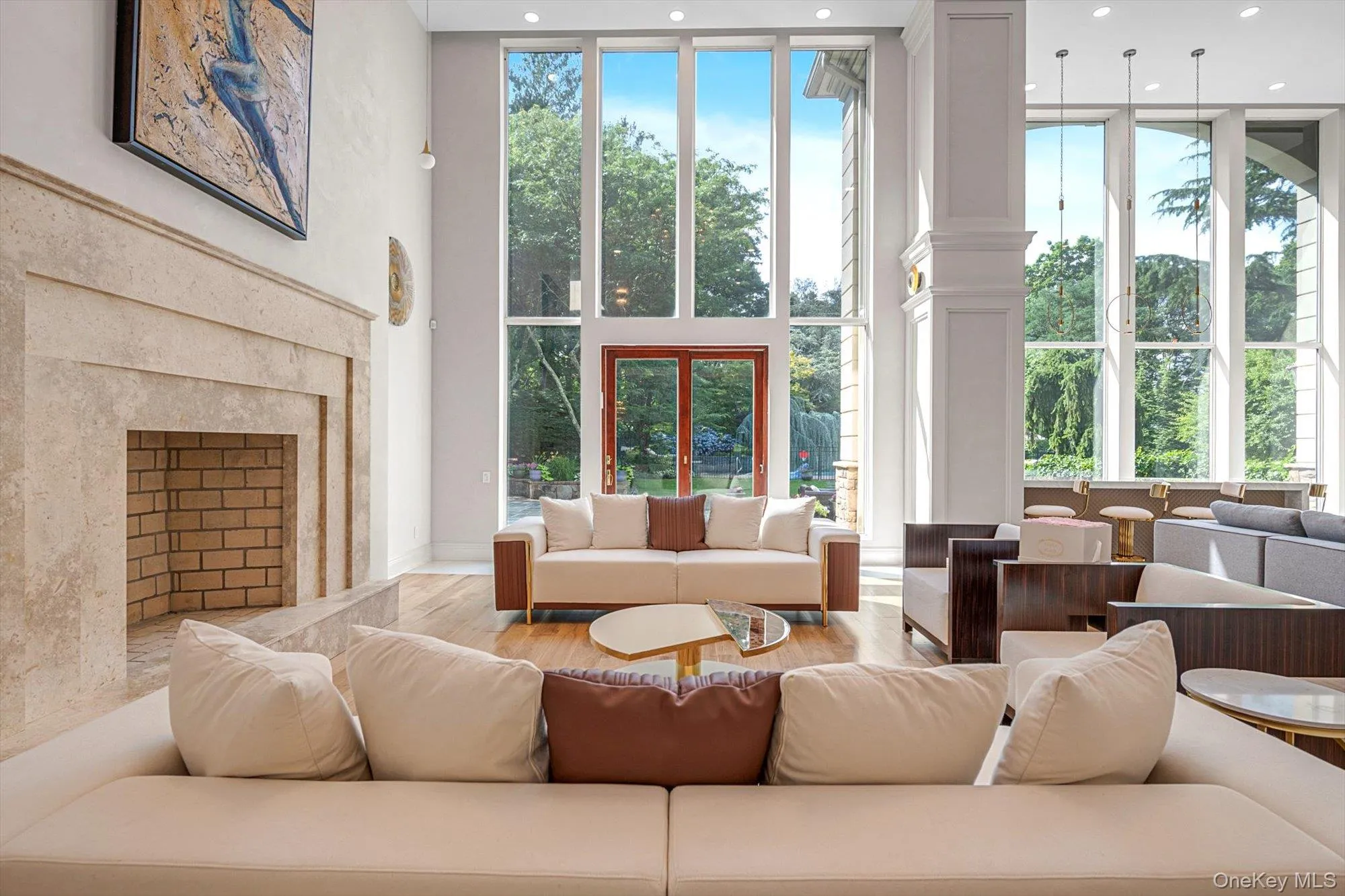 Living room with a towering ceiling, plenty of natural light, and recessed lighting Living room with a towering ceiling, plenty of natural light, and recessed lighting