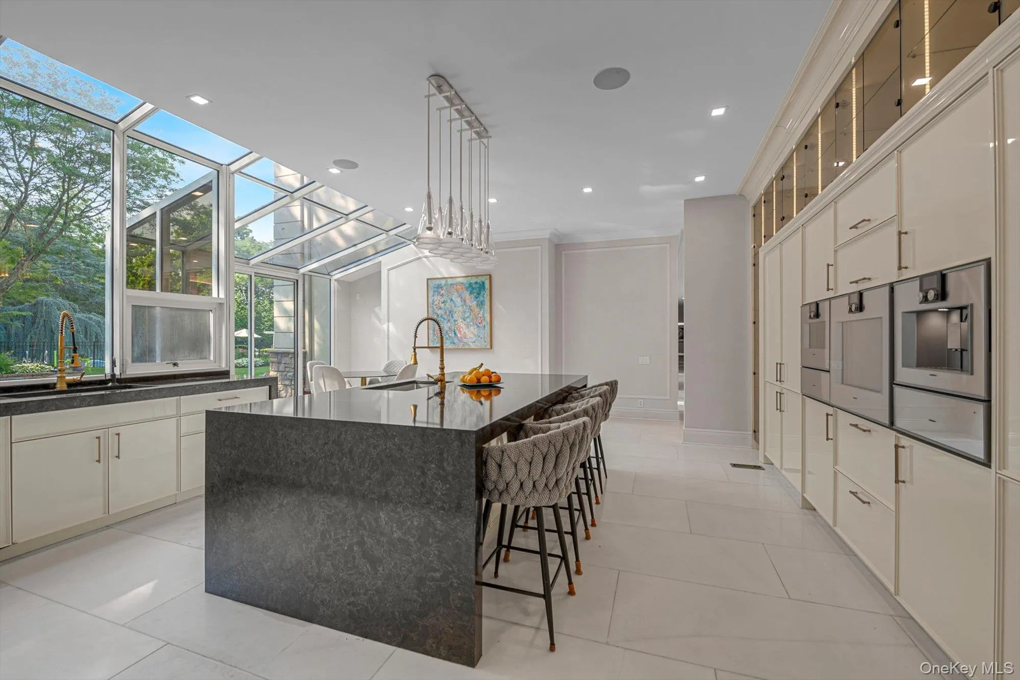 Kitchen with white cabinetry, light tile patterned floors, glass insert cabinets, and recessed lighting Kitchen with white cabinetry, light tile patterned floors, glass insert cabinets, and recessed lighting