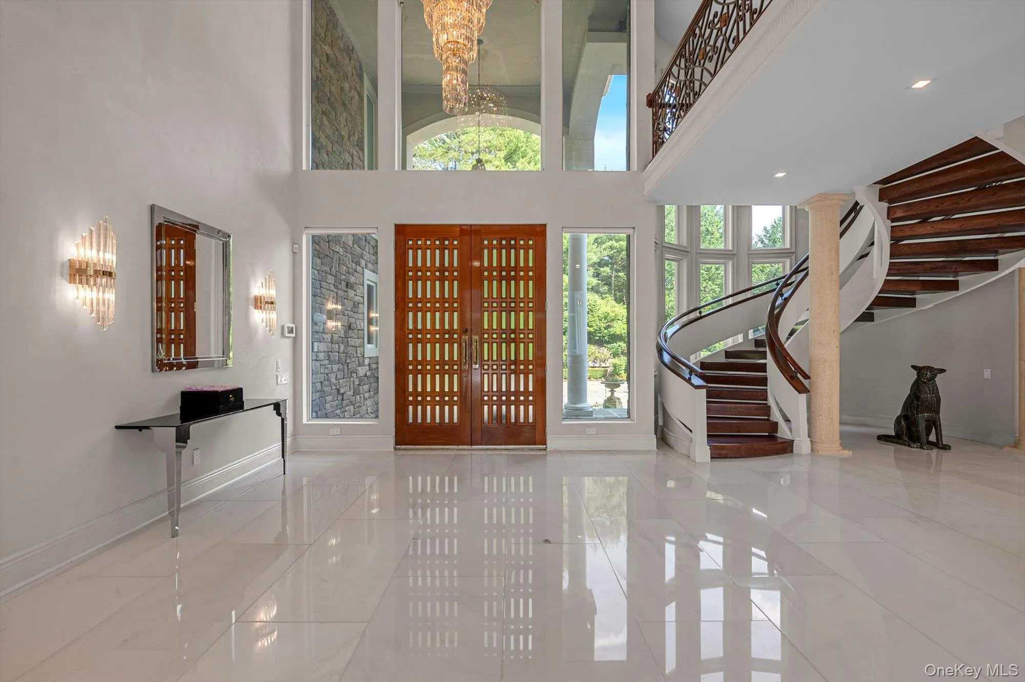 Foyer with stairway, a chandelier, a towering ceiling, and tile patterned flooring Foyer with stairway, a chandelier, a towering ceiling, and tile patterned flooring