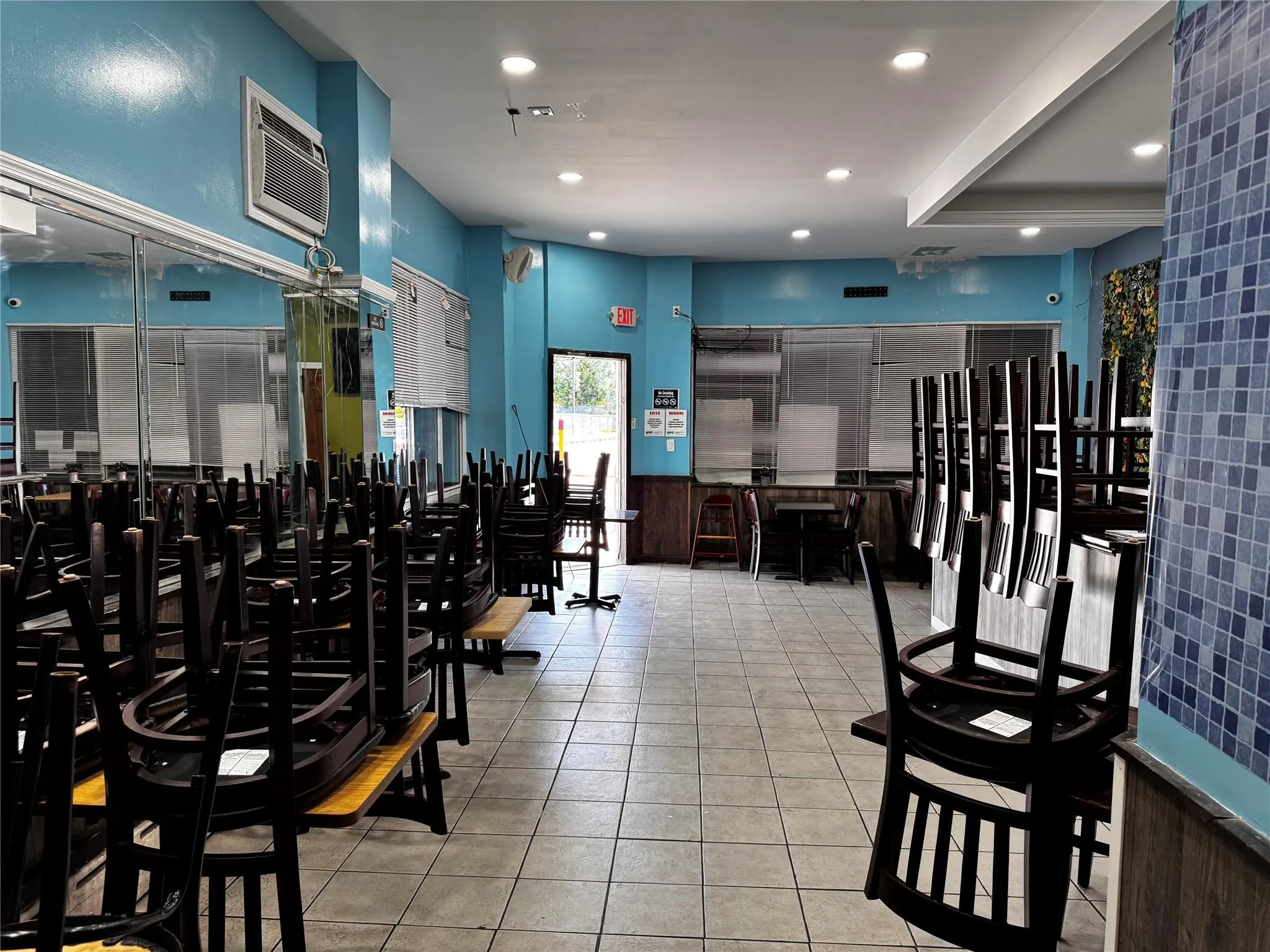 Workout area featuring wainscoting, a wall mounted air conditioner, recessed lighting, and tile patterned floors Workout area featuring wainscoting, a wall mounted air conditioner, recessed lighting, and tile patterned floors