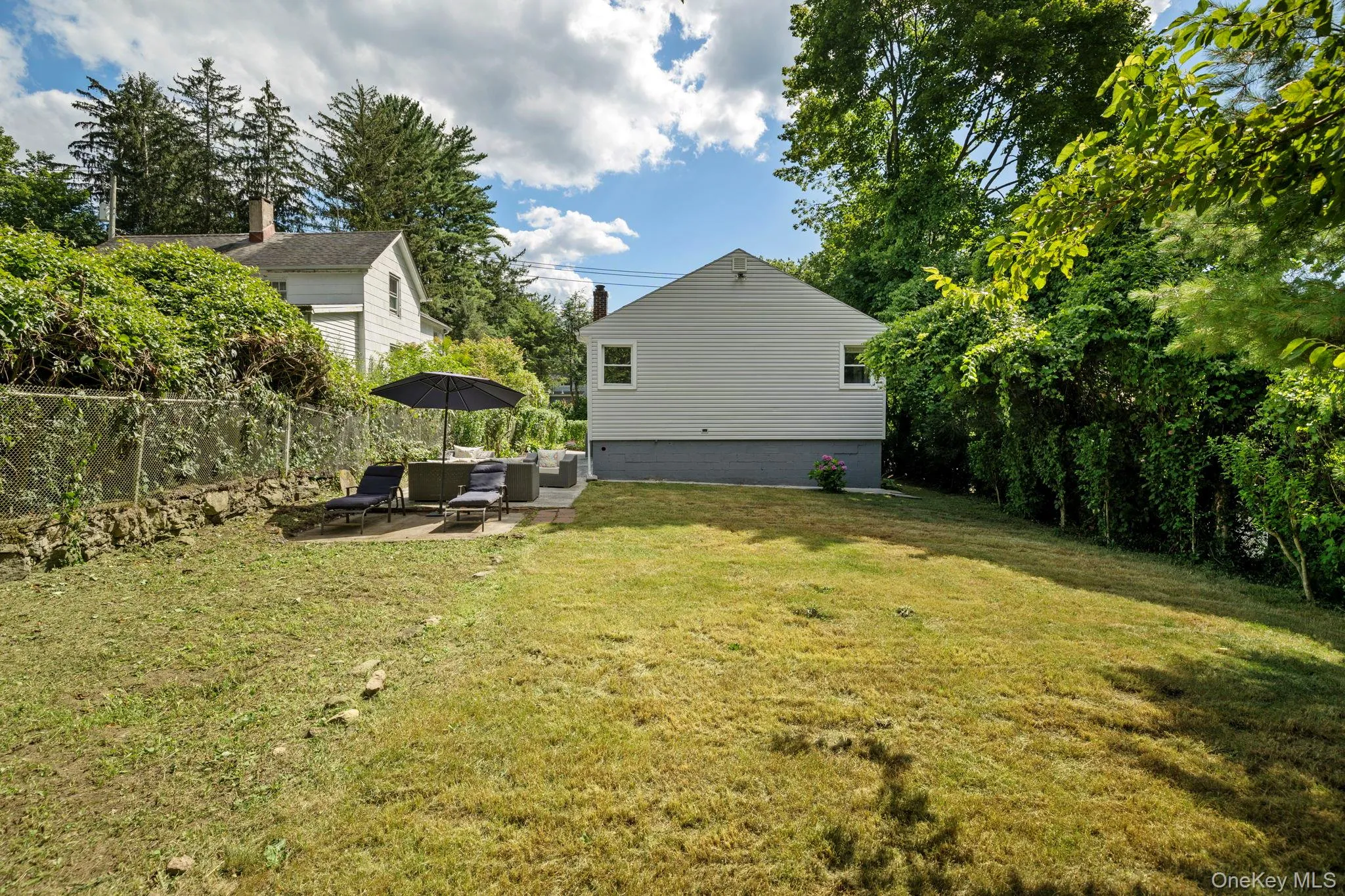 View of yard with an outdoor hangout area and a patio area View of yard with an outdoor hangout area and a patio area