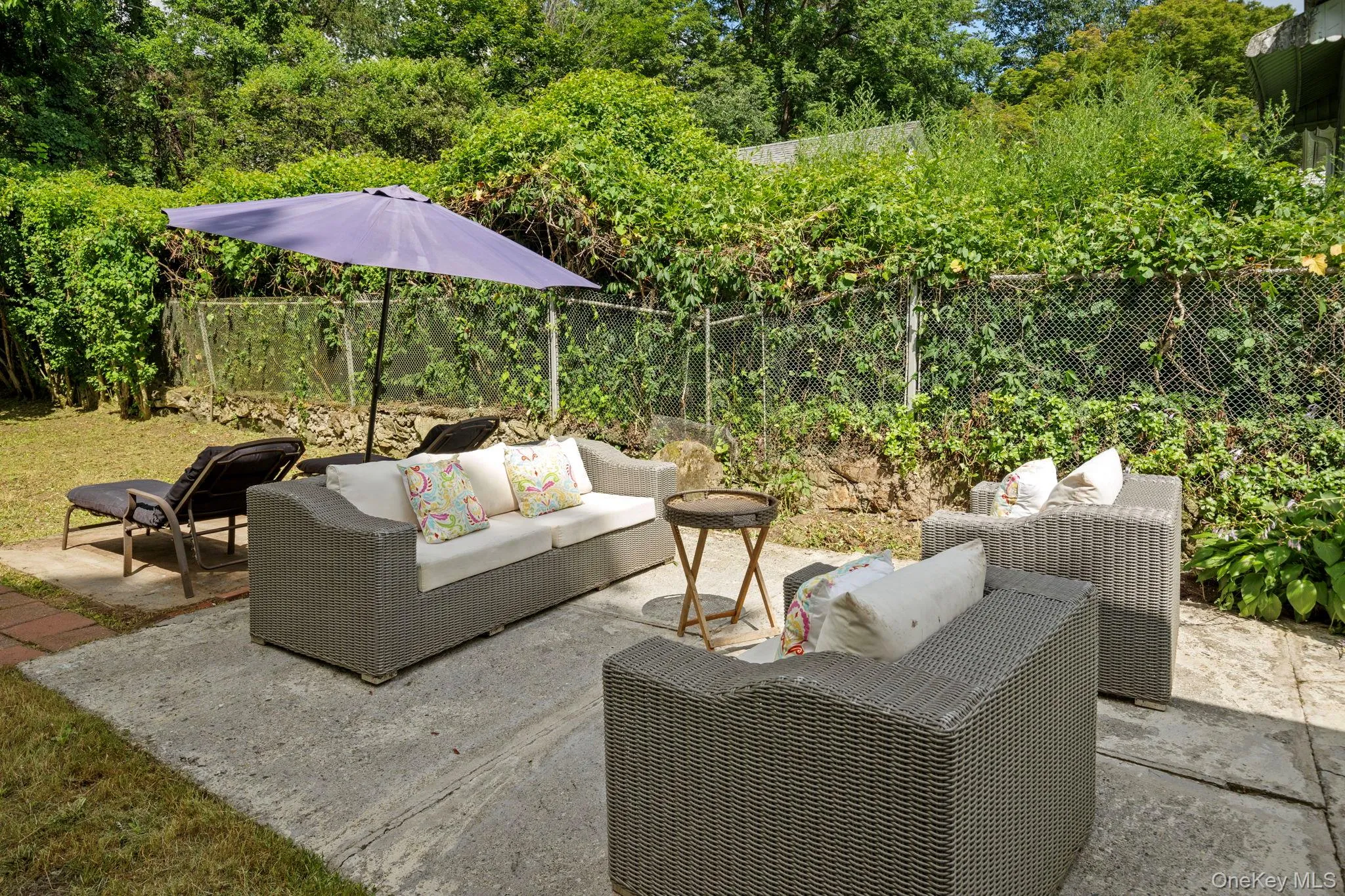 Fenced backyard featuring an outdoor living space and a patio Fenced backyard featuring an outdoor living space and a patio