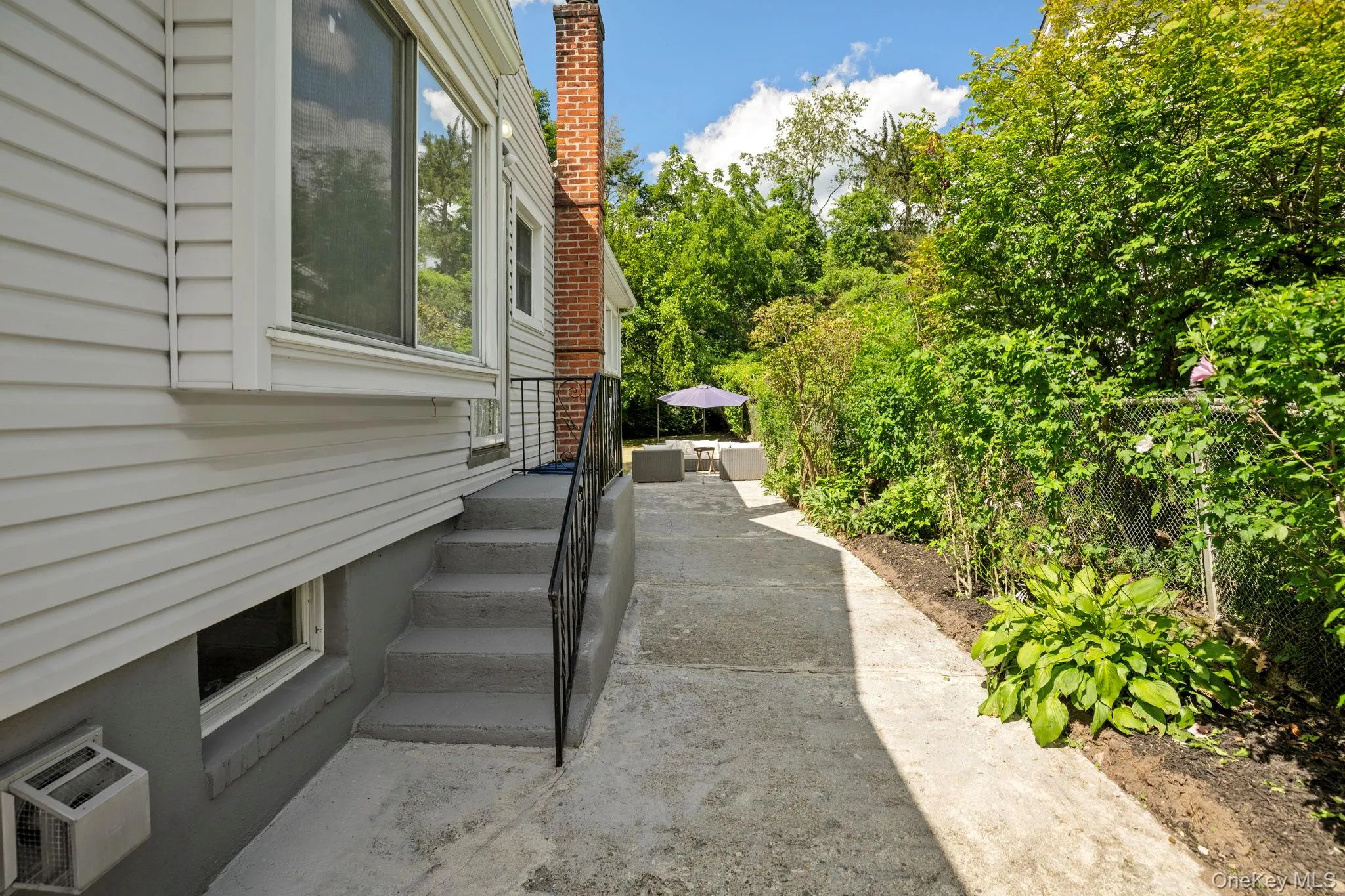 View of home's exterior featuring a wall unit AC View of home's exterior featuring a wall unit AC
