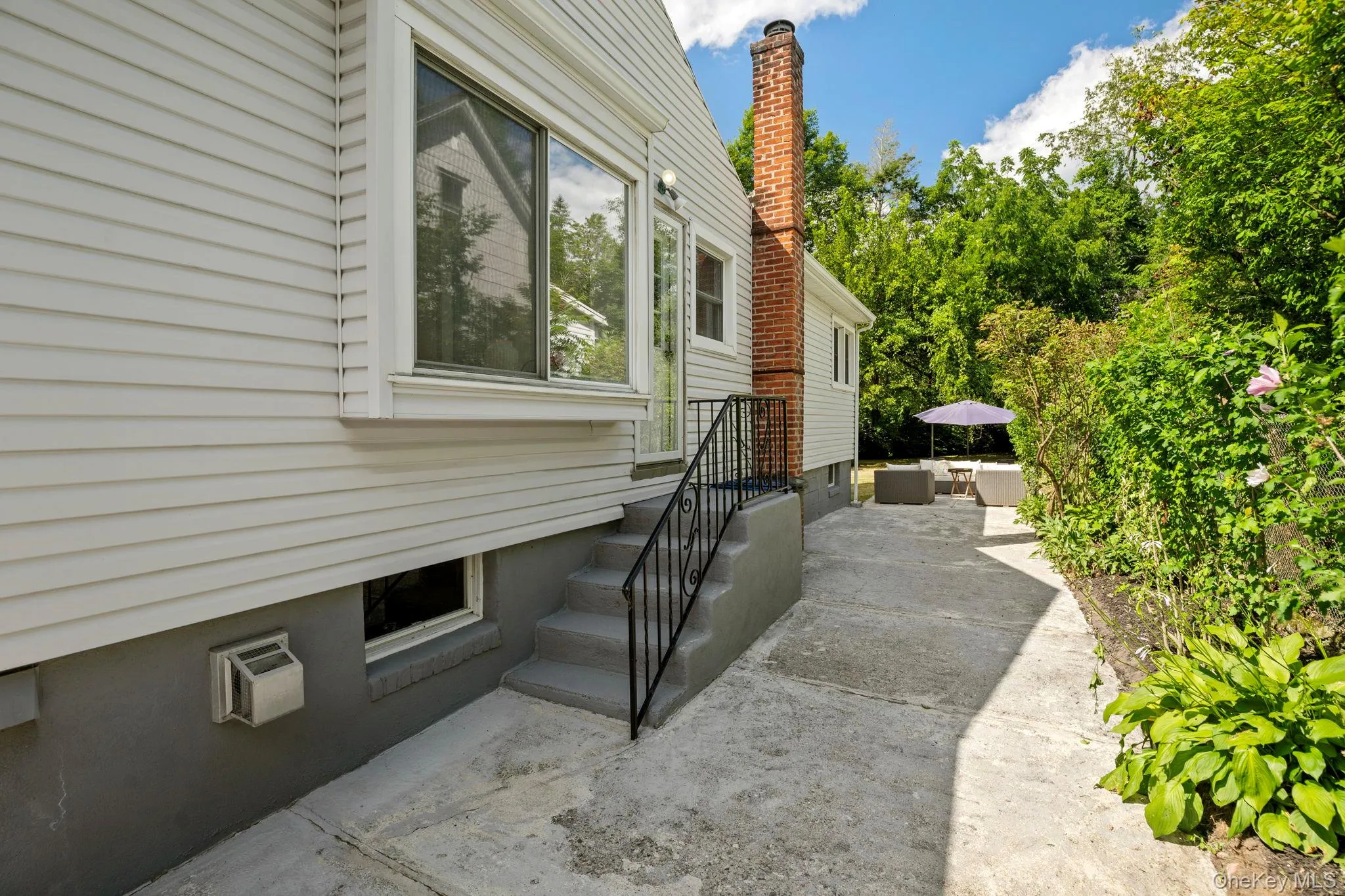 View of home's exterior featuring a patio area and a chimney View of home's exterior featuring a patio area and a chimney