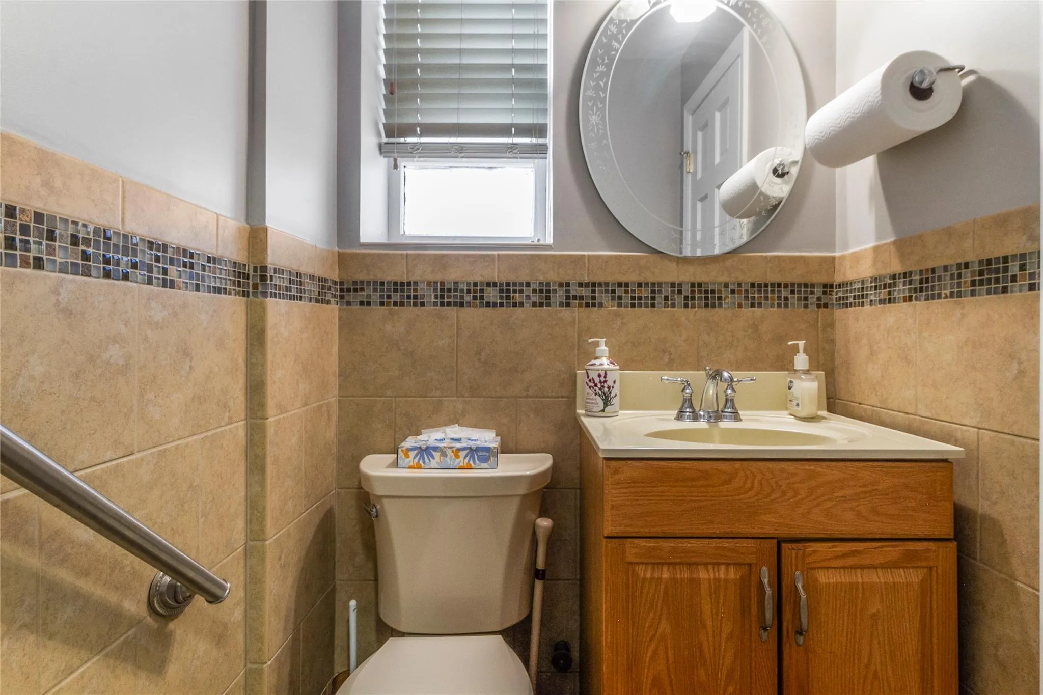 Bathroom featuring vanity and tile walls Bathroom featuring vanity and tile walls
