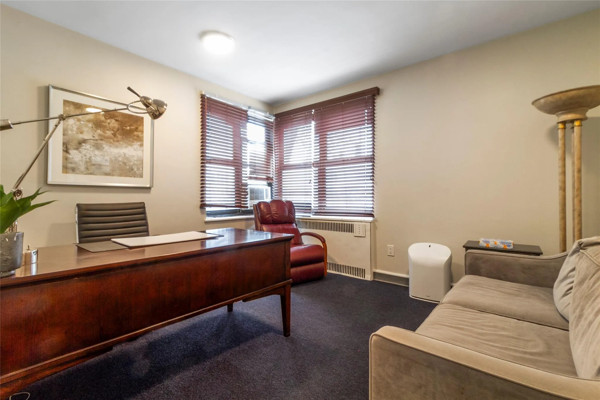 Carpeted home office featuring radiator and baseboards Carpeted home office featuring radiator and baseboards