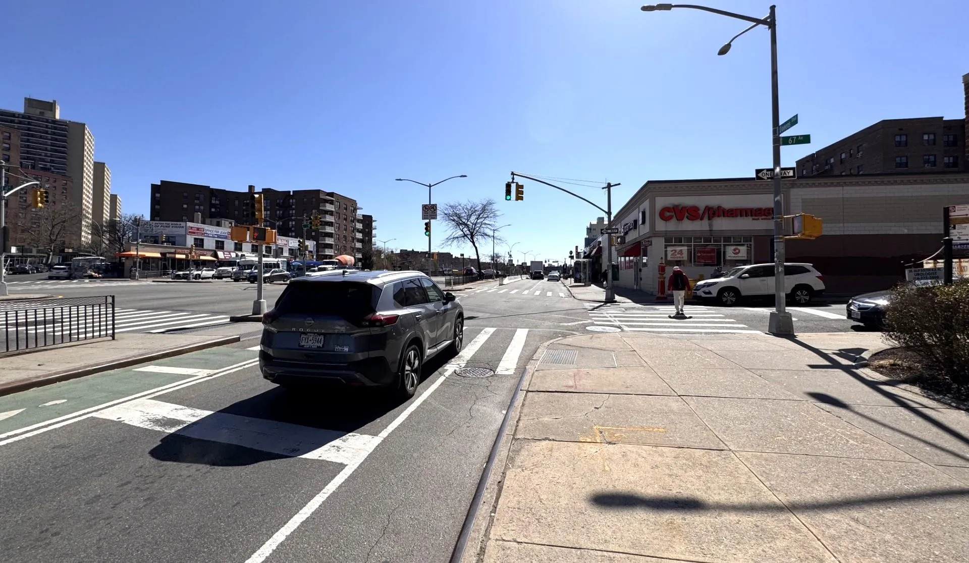 View of asphalt road with street lighting, sidewalks, and curbs View of asphalt road with street lighting, sidewalks, and curbs