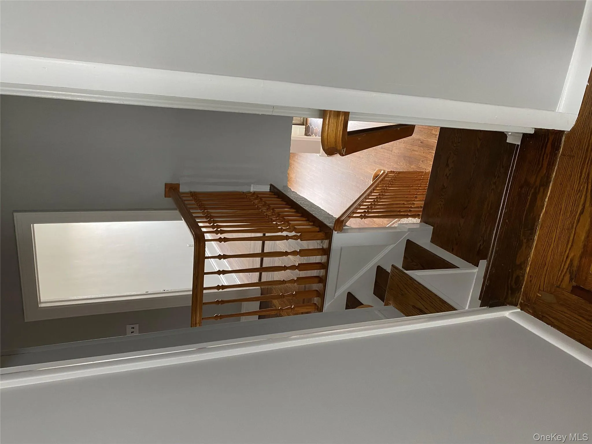 Stairs featuring baseboards and wood finished floors Stairs featuring baseboards and wood finished floors