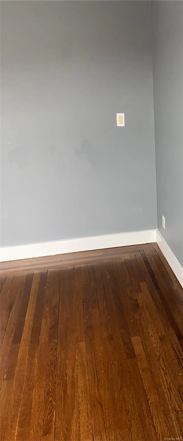 Empty room with hardwood / wood-style floors and baseboards Empty room with hardwood / wood-style floors and baseboards