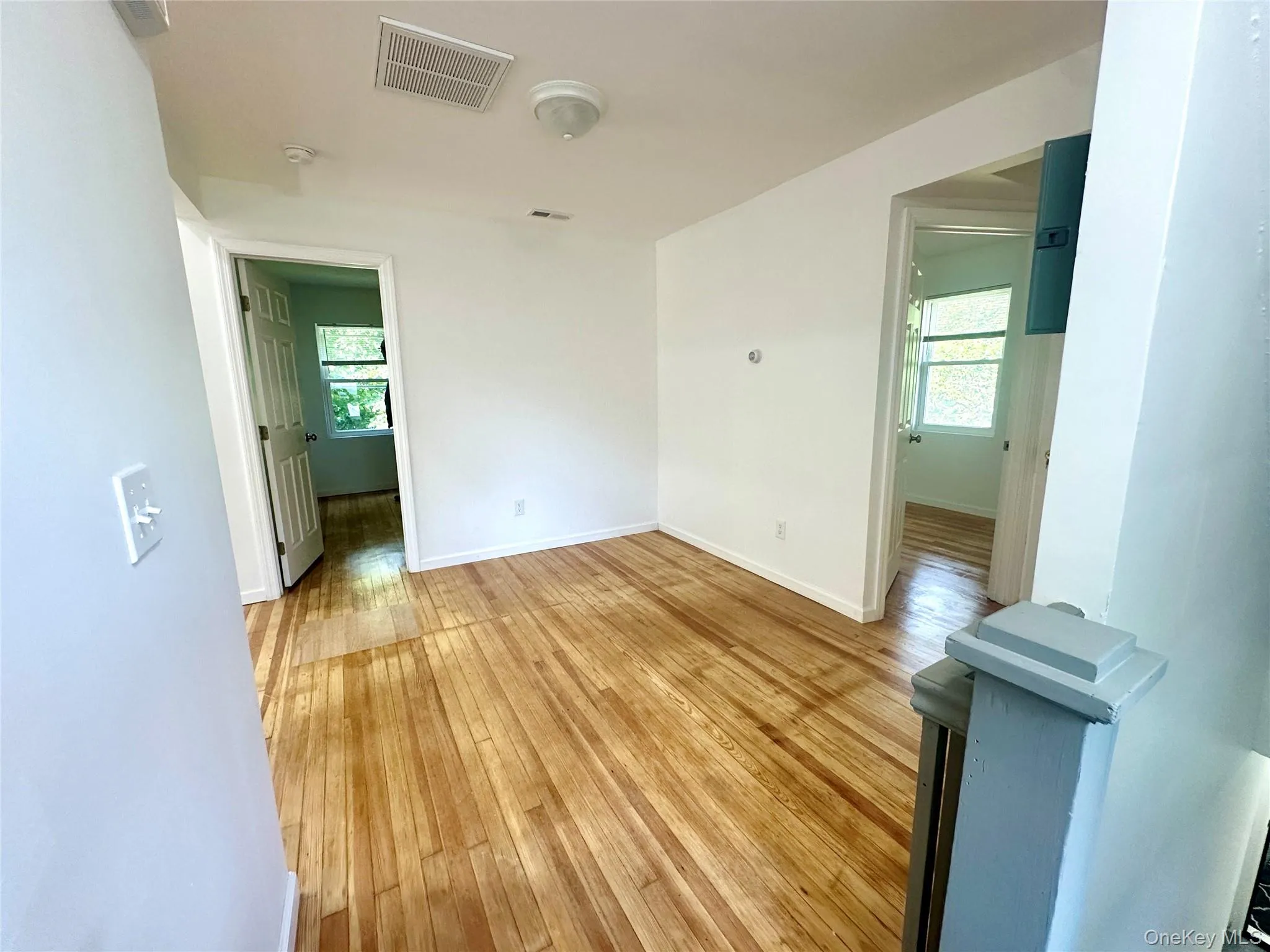 Empty room with light wood-style flooring and baseboards Empty room with light wood-style flooring and baseboards