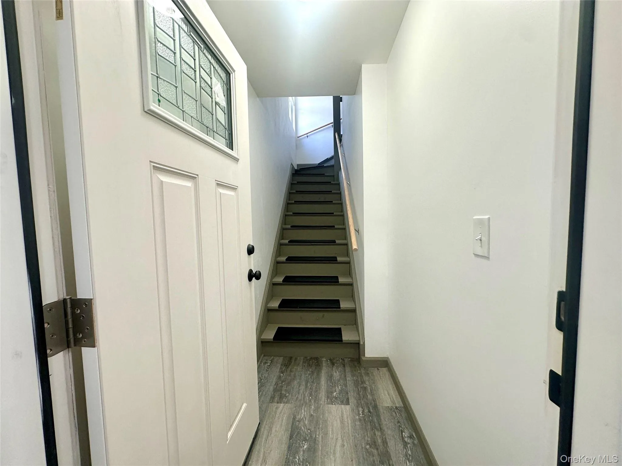 Staircase featuring wood finished floors and baseboards Staircase featuring wood finished floors and baseboards