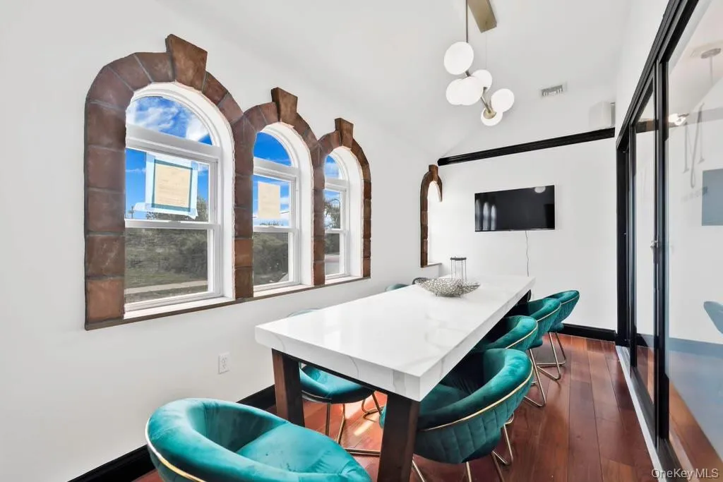 Conference room featuring vaulted ceiling and dark wood finished floors Conference room featuring vaulted ceiling and dark wood finished floors