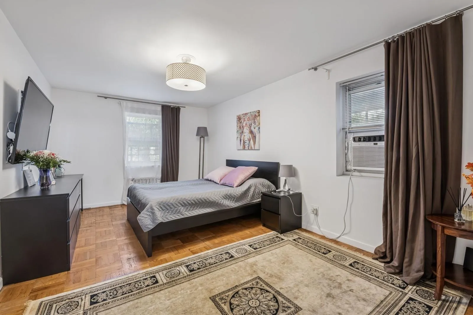 Bedroom featuring baseboards and cooling unit Bedroom featuring baseboards and cooling unit